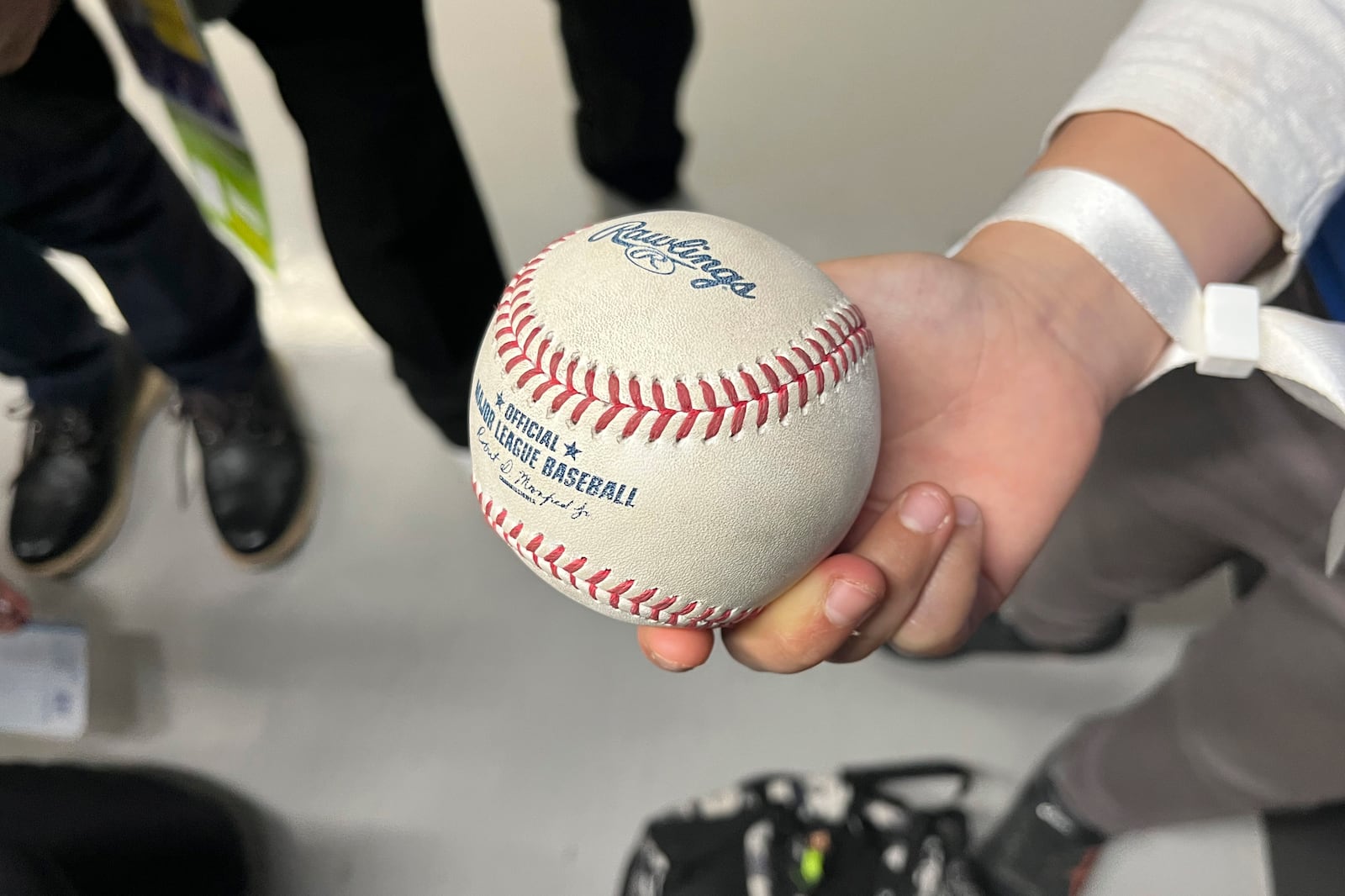 A 10-year-old boy who caught the home run ball hit by the Los Angeles' Shohei Ohtani, shows the ball to the media during an MLB Tokyo Series baseball game between the Dodgers and the Chicago Cubs at the Tokyo Dome in Tokyo, Wednesday, March 19, 2025. (AP Photo/Stephen Wade)