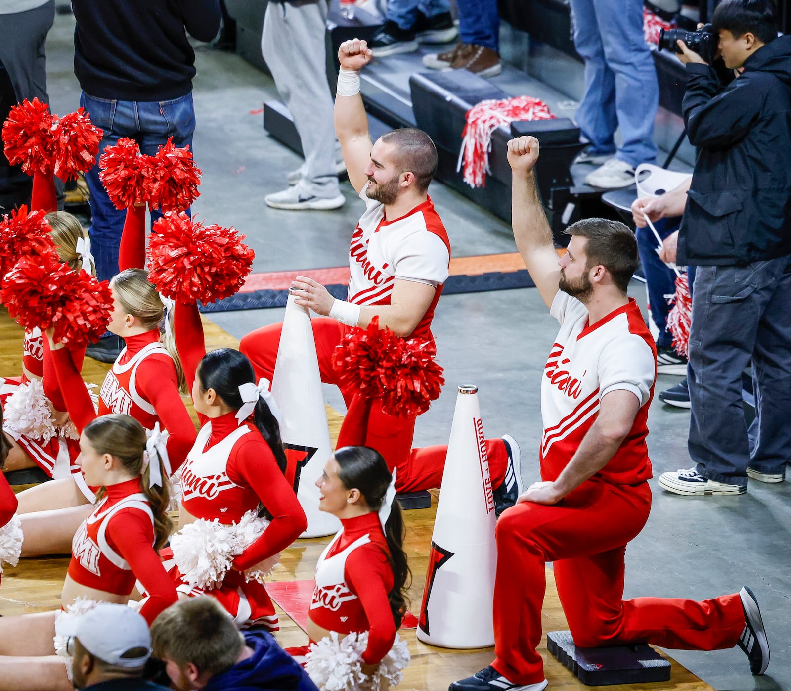 Miami University senior cheerleaders Braden Cowger, left, and Evan Conley cheer on the Miami Redhawks basketball team during their game Friday, March 7, 2025 at Millett Hall in Oxford. Cowger and Conley are two of four male cheerleaders who are also engineering majors at Miami. NICK GRAHAM/STAFF