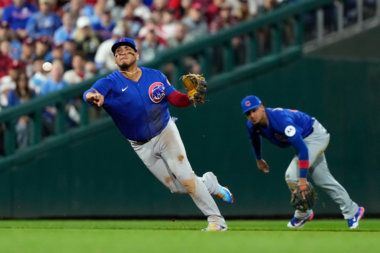 FILE - Chicago Cubs third baseman Isaac Paredes, left, throws to first after fielding a groundout by Philadelphia Phillies' Alec Bohm during the fifth inning of a baseball game, Monday, Sept. 23, 2024, in Philadelphia. (AP Photo/Matt Slocum, File)