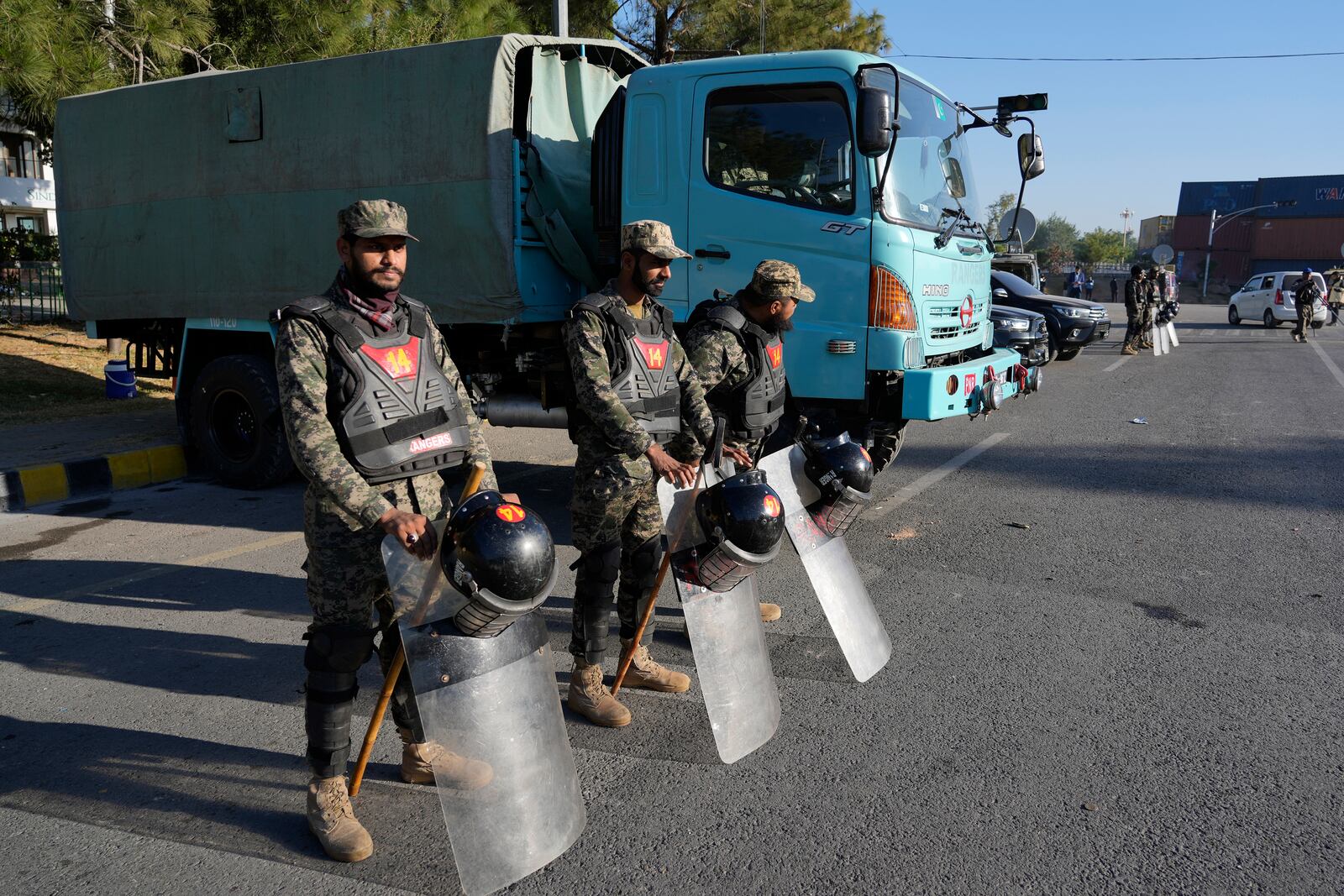 Paramilitary soldiers stand guard along roadside to ensure security in Islamabad, Pakistan, Wednesday, Nov. 27, 2024. (AP Photo/Anjum Naveed)