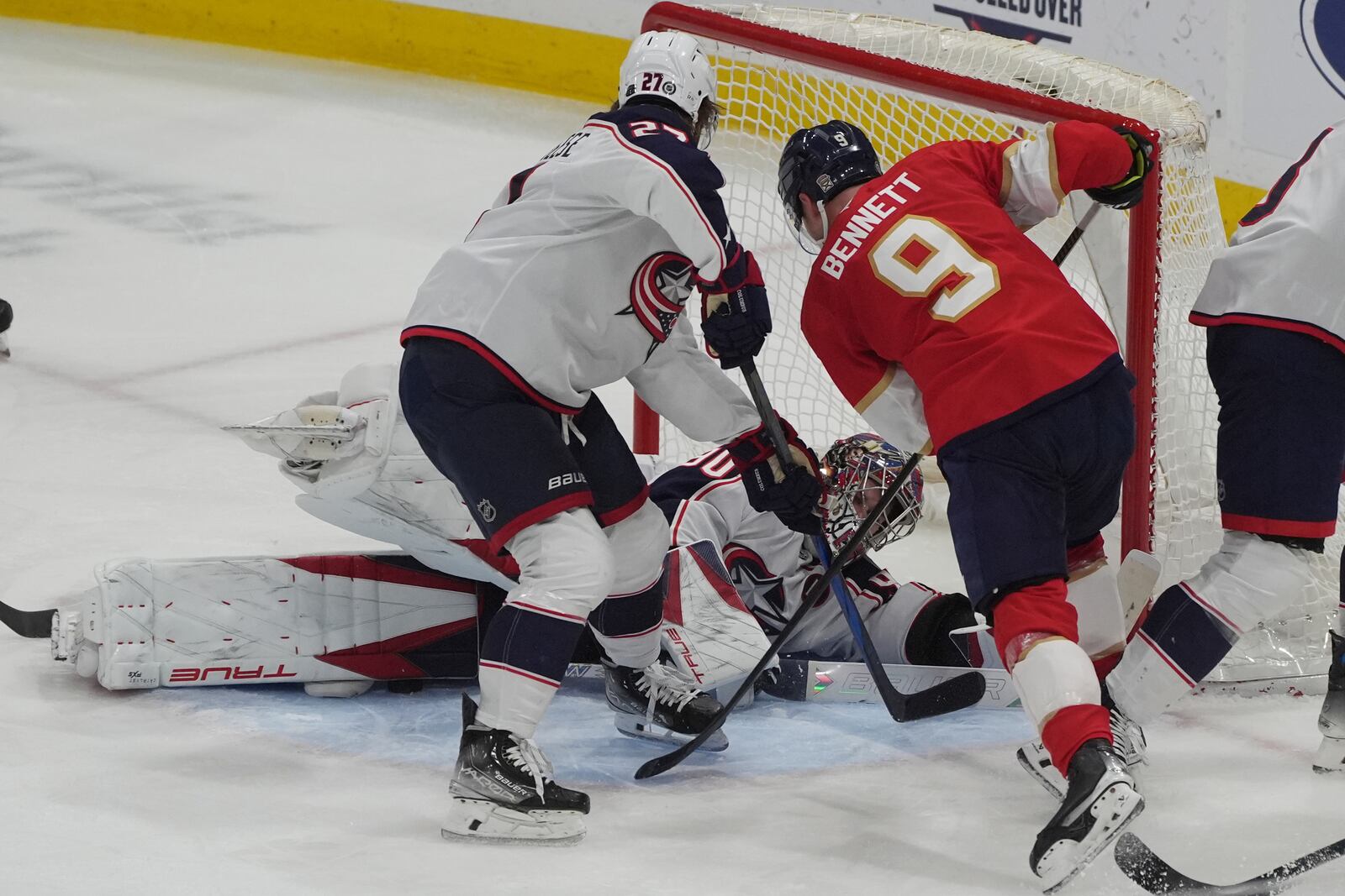 Columbus Blue Jackets goaltender Elvis Merzlikins (90) stops a shot by Florida Panthers center Sam Bennett (9) during the second period of an NHL hockey game, Thursday, March 6, 2025, in Sunrise, Fla. (AP Photo/Marta Lavandier)