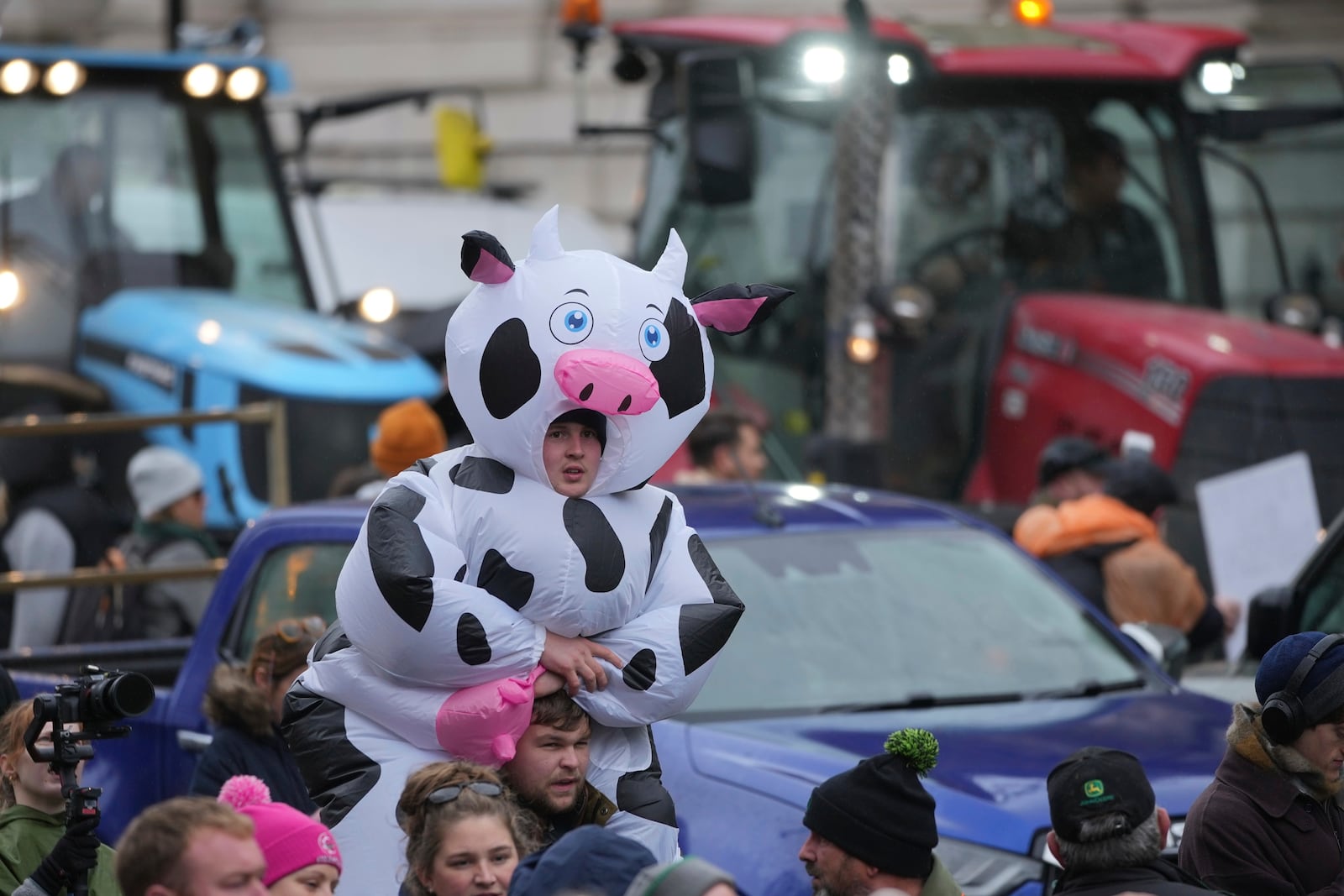 The National Farmers' Union members attend a protest against the planned changes to tax rules, in London, Tuesday, Nov. 19, 2024. (AP Photo/Kin Cheung)