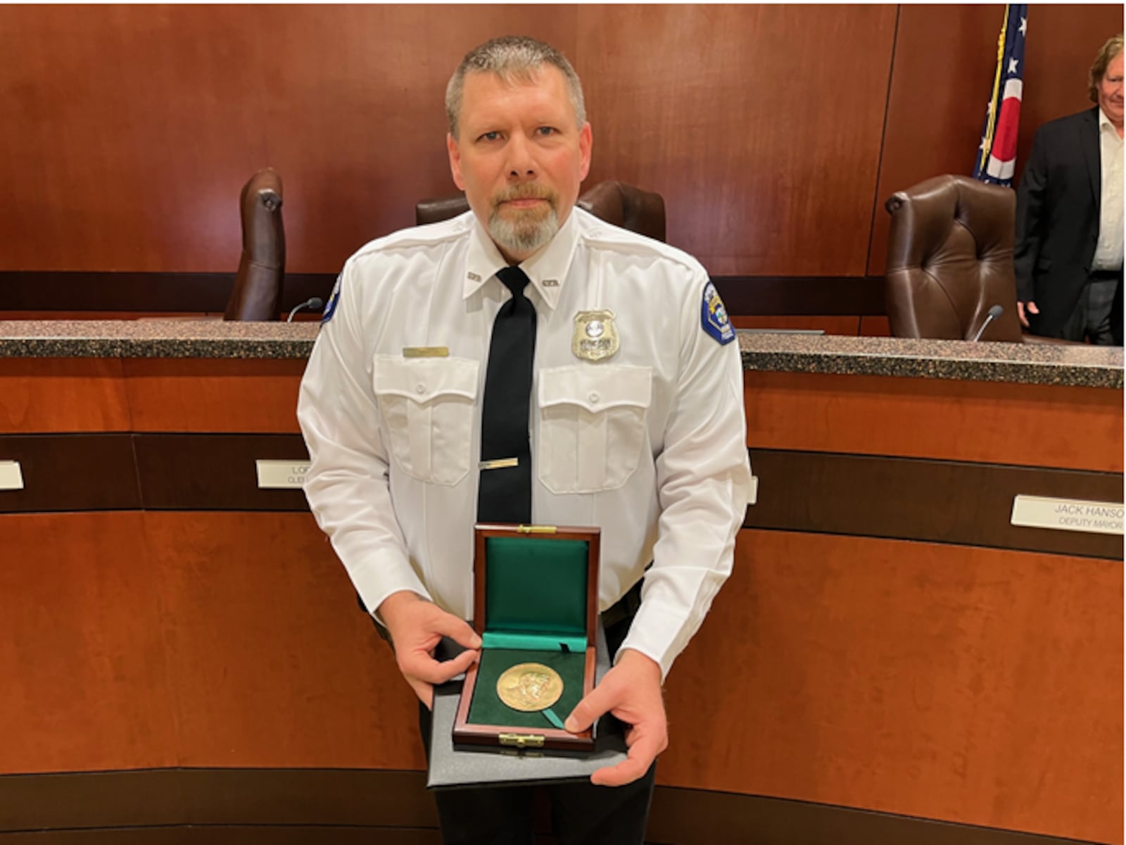 Springboro police Officer Heath Martin displays the Carnegie Medal for Heroism for saving the life of a disabled man who was trapped in his burning home in June 2023.  ED RICHTER/STAFF