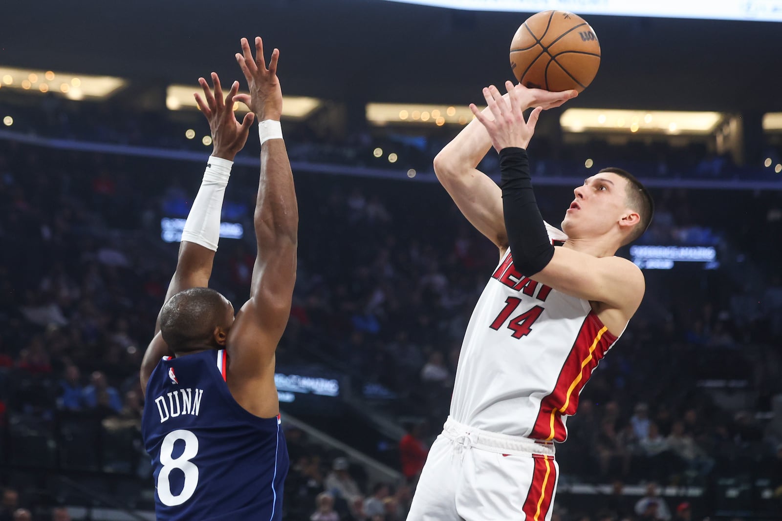 Miami Heat guard Tyler Herro (14) looks to shoot against Los Angeles Clippers guard Kris Dunn (8) during the first half of an NBA basketball game, Monday, Jan. 13, 2025, in Los Angeles. (AP Photo/Jessie Alcheh)