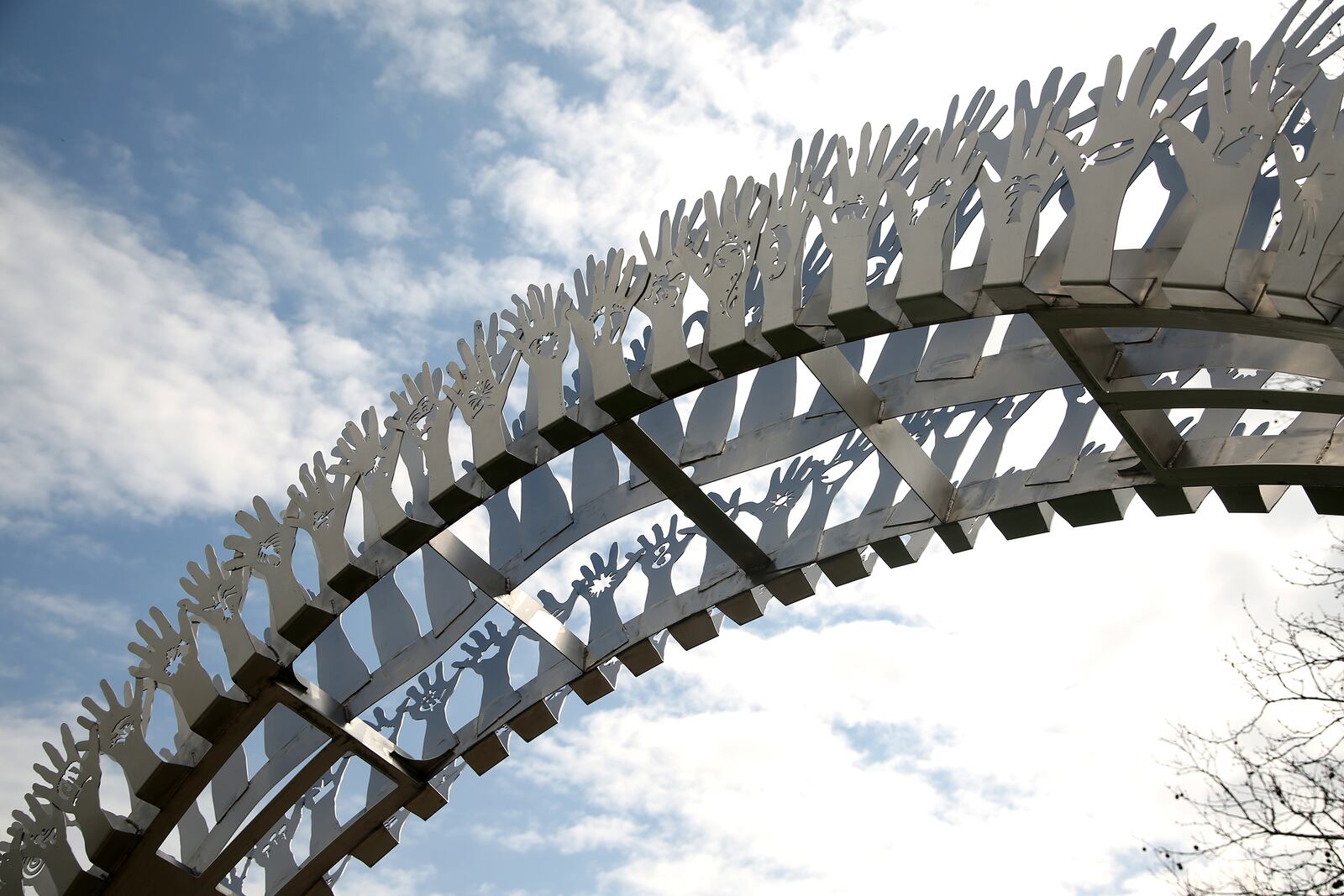 âFriendship Arch," by artist Tess Little, is located in Kettering's Wenzler Park. LISA POWELL / STAFF