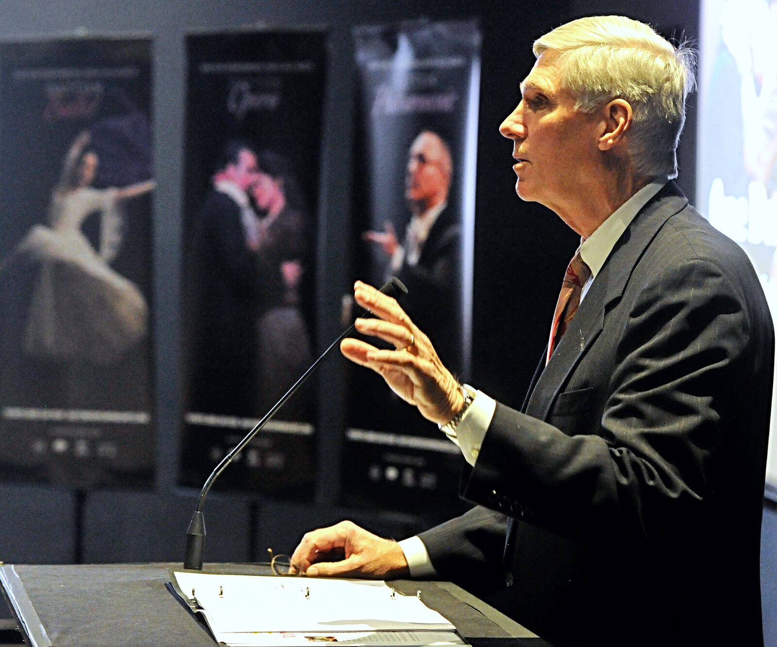 John Beran, Board Chair, for the Dayton Performing Arts Alliance, talks to the audience about the One Dayton. One Alliance, at the Schuster Center, Mathile Theatre Wednesday. MARSHALL GORBY / STAFF