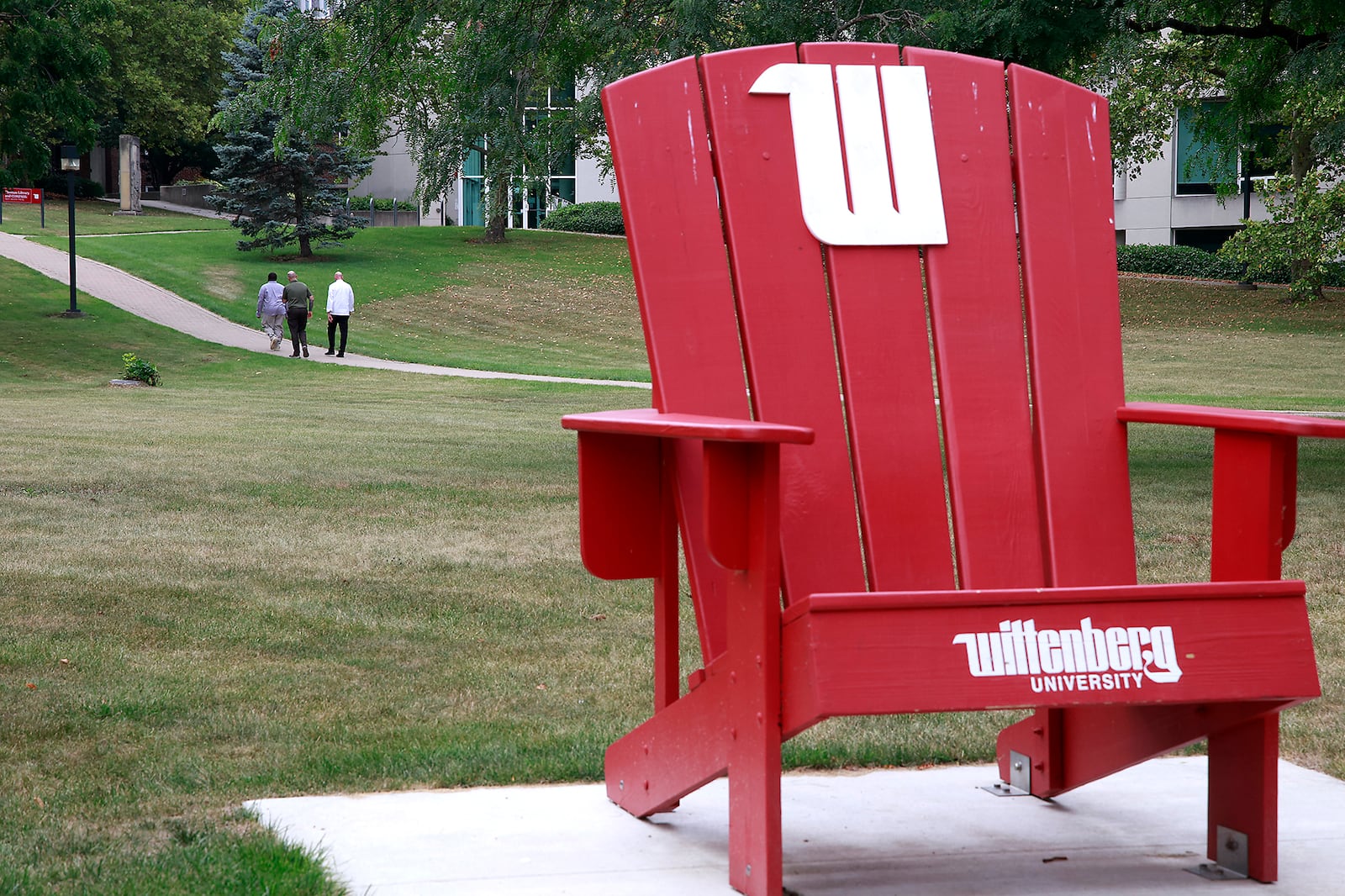 Three men walk across the campus of Wittenberg University Thursday, August 1, 2024. BILL LACKEY/STAFF