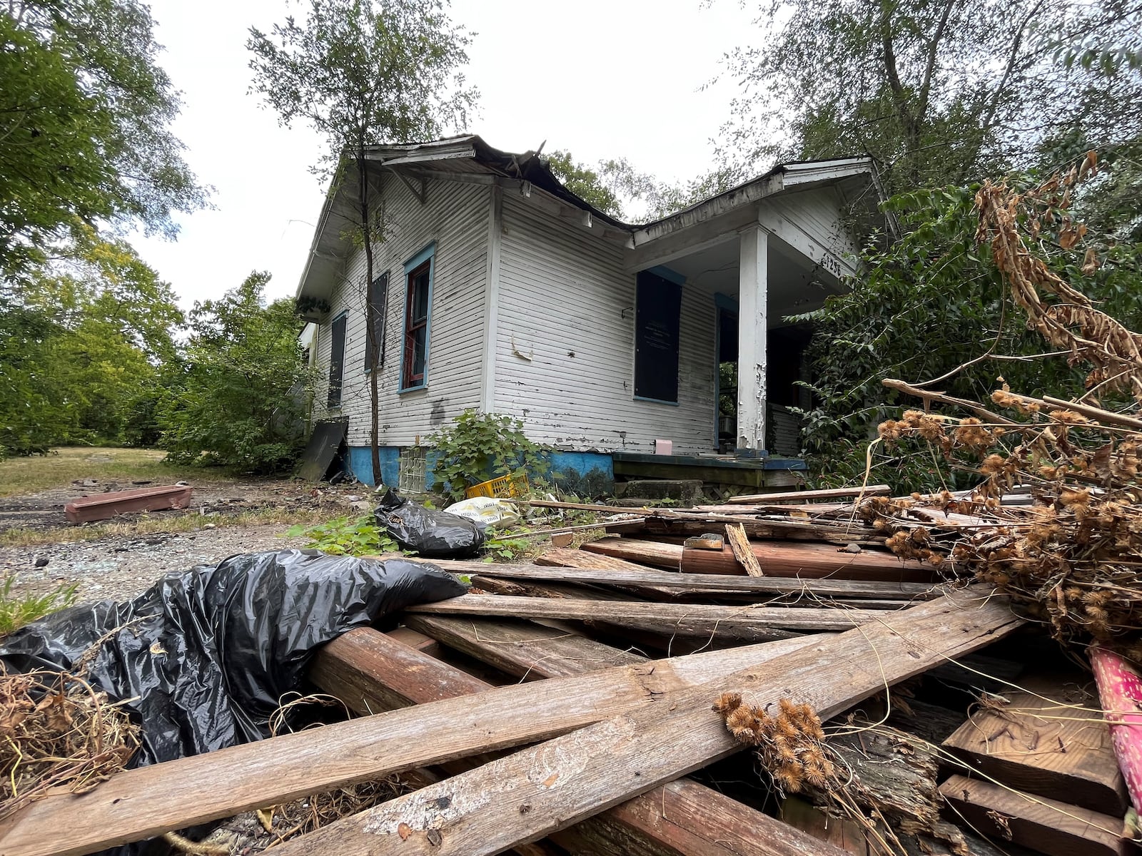 A fire-damaged home that is slated for demolition in West Dayton. CORNELIUS FROLIK / STAFF