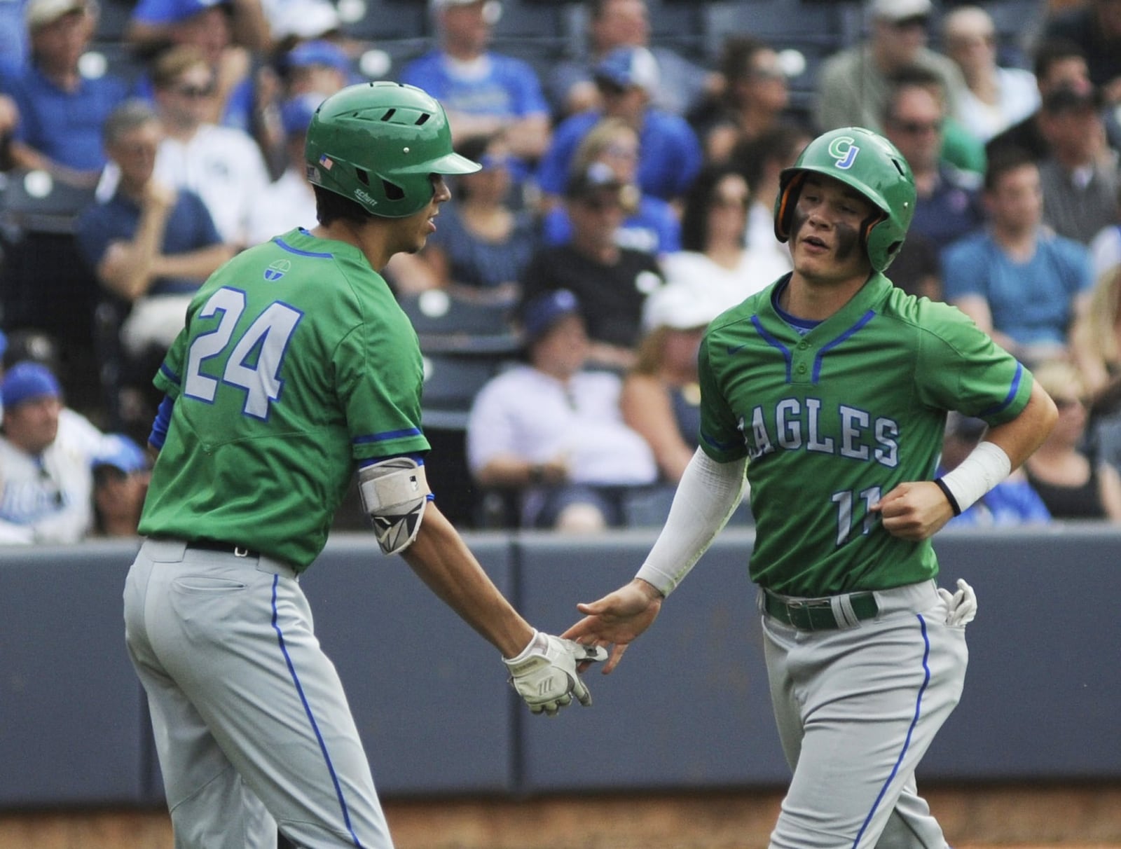 CJ’s Sebastian Gongora (left) greets Andrew Simones. Chaminade Julienne defeated Gates Mills Gilmour Academy 4-2 to defend its D-II high school baseball state championship at Canal Park in Akron on Sunday, June 9, 2019. MARC PENDLETON / STAFF