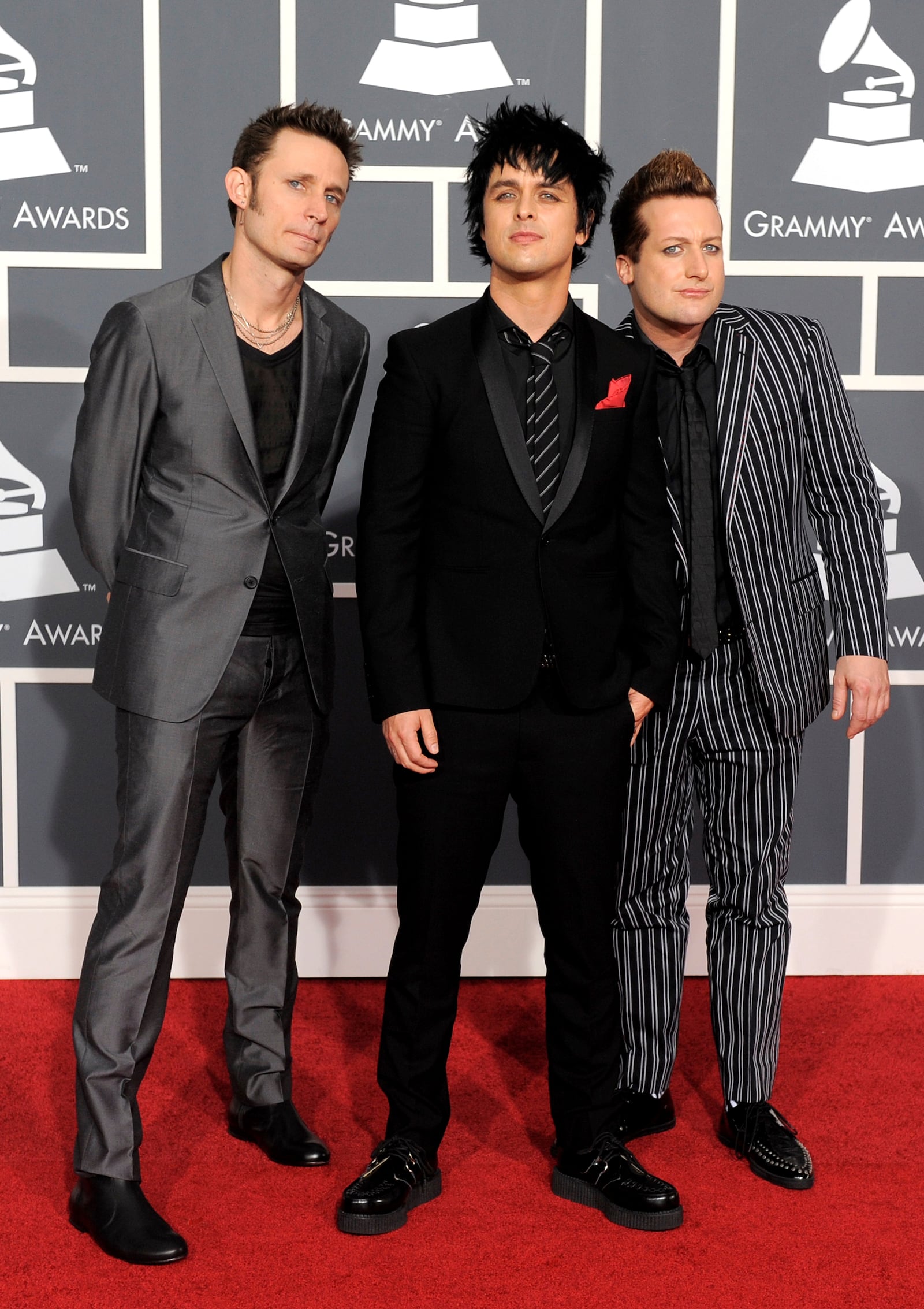 FILE - Members of Green Day, from left, Mike Dirnt, Billie Joe Armstrong and Tre Cool, appear at the Grammy Awards in Los Angeles on Jan. 31, 2010. (AP Photo/Chris Pizzello, File)