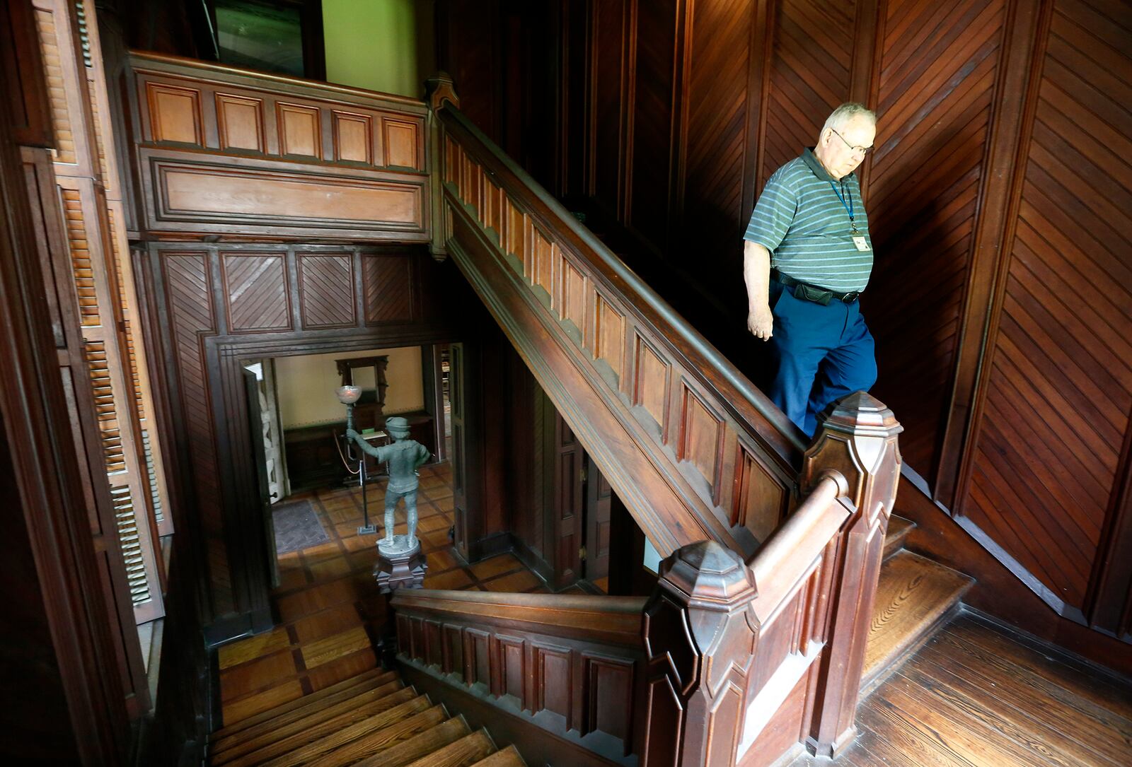 Jim Heiser, an interpretor at the Piatt Castles for 14-years, descends a staircase at Mac-O-Chee. The home was constructed in two sections beginning in the 1860s and completed in the 1880s. LISA POWELL / STAFF