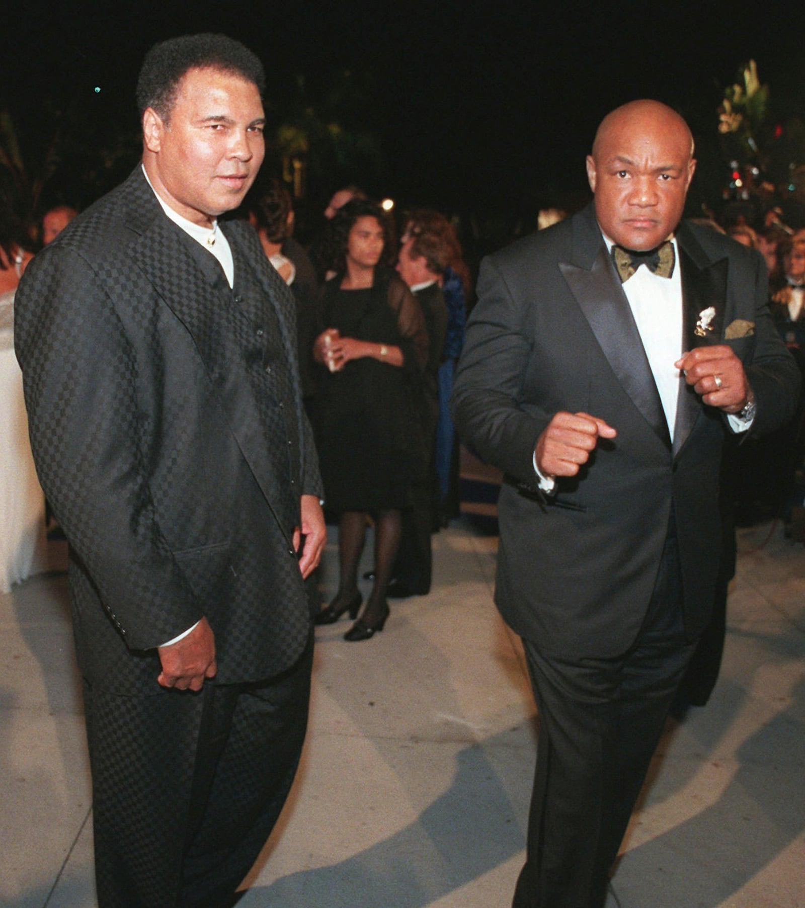 FILE - Muhammad Ali, left, and George Foreman arrive at a Vanity Fair Oscar party in West Hollywood, Calif, March 24, 1997. (AP Photo/E.J. Flynn, File)