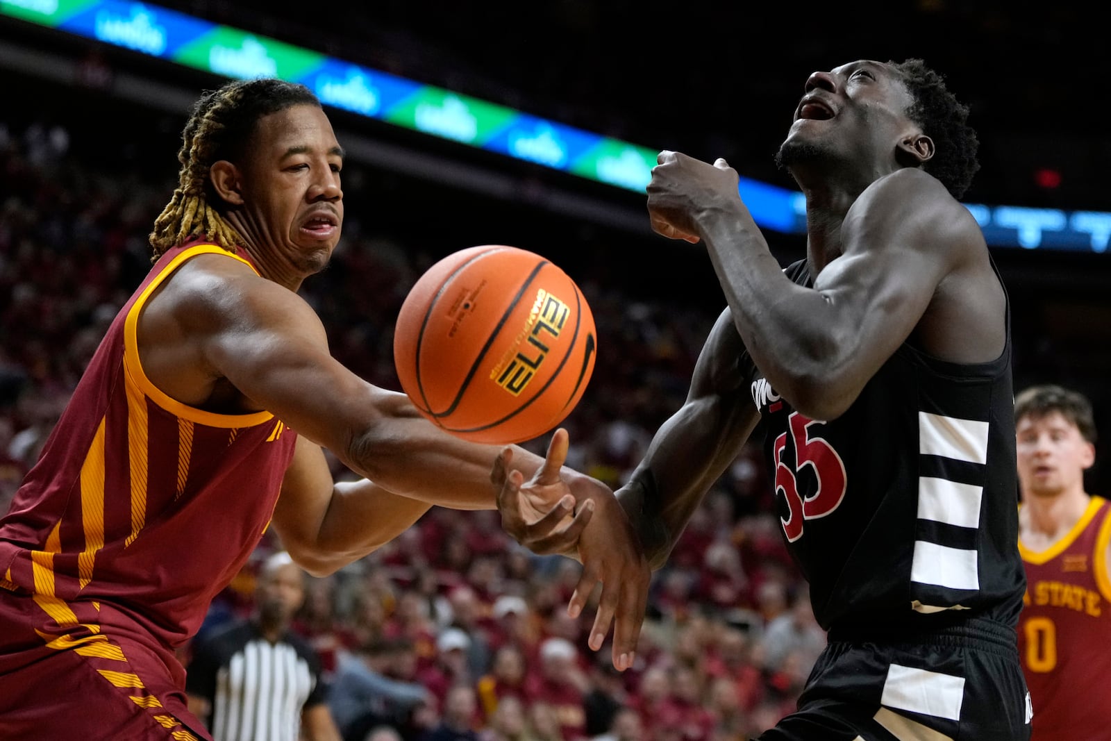 Cincinnati forward Aziz Bandaogo (55) is fouled by Iowa State center Dishon Jackson, left, during the first half of an NCAA college basketball game Saturday, Feb. 15, 2025, in Ames, Iowa. (AP Photo/Charlie Neibergall)