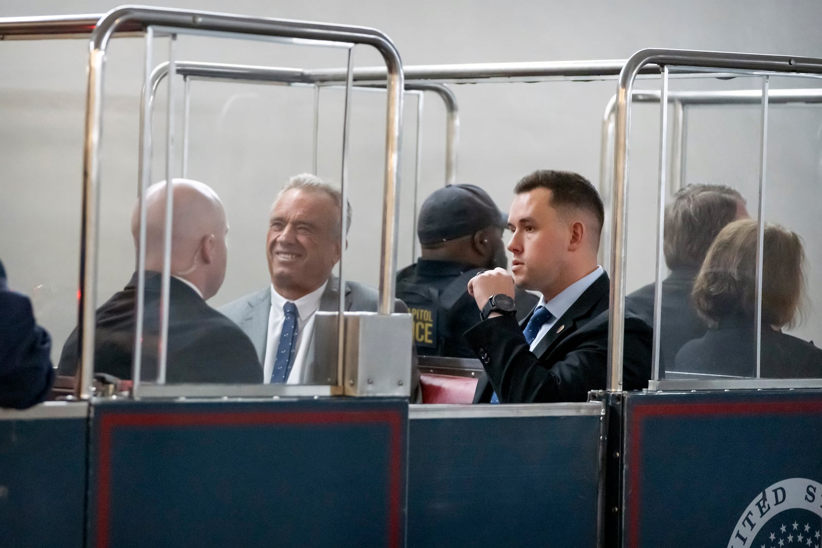 Robert Kennedy Jr., second from right, President-elect Donald Trump's pick to lead the Health and Human Services Department, rides the Capitol subway as he travels between meetings with senators on Capitol Hill, Tuesday, Dec. 17, 2024, in Washington. (AP Photo/Mark Schiefelbein)