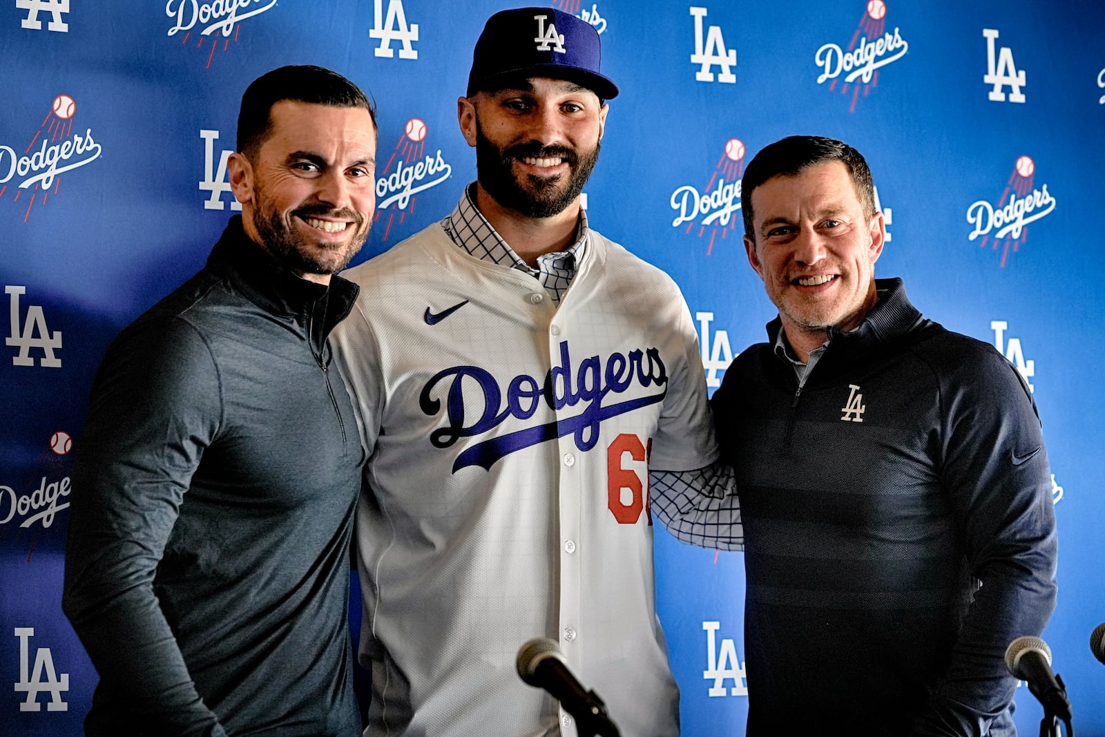 Executive Vice President and General Manager of the Los Angeles Dodgers Brandan Gomes, left, poses with left-handed reliever Tanner Scott and Andrew Friedman president of baseball operations right, at an introduction news conference at Dodger Stadium in Los Angeles on Thursday, Jan. 23, 2025. (AP Photo/Richard Vogel)