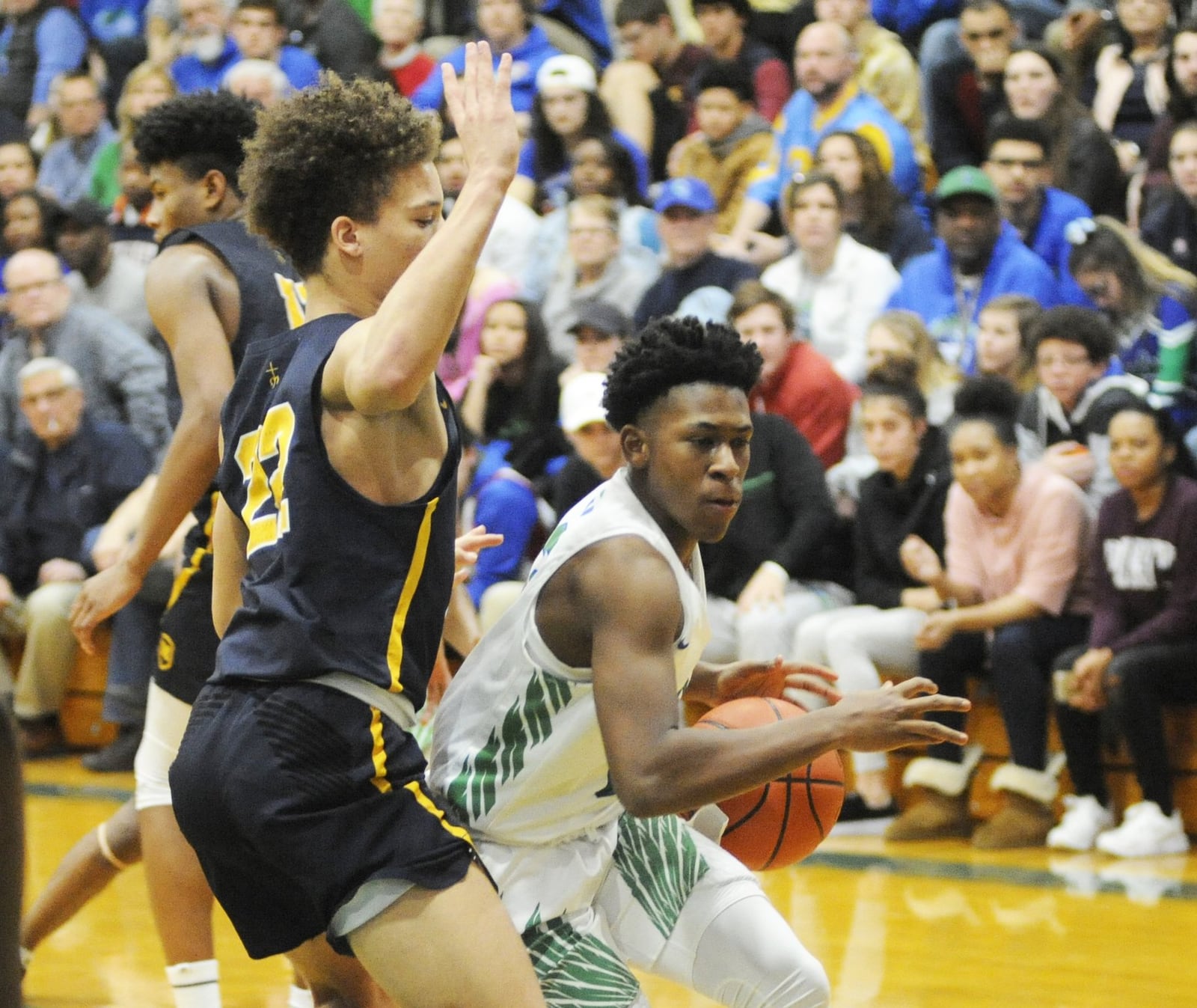 CJ’s Anthony Solomon (with ball) draws defender Max Land. CJ lost to visiting Cin. Moeller 62-55 in a boys high school basketball game on Sat., Feb. 2, 2019. MARC PENDLETON / STAFF