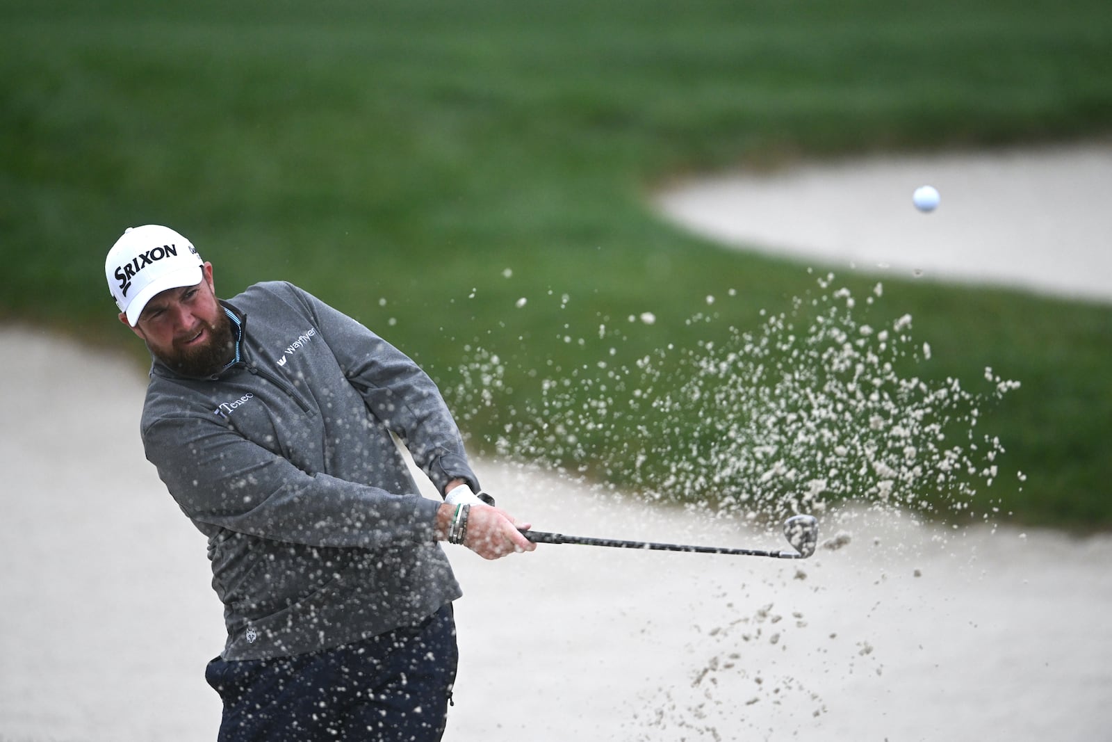 Shane Lowry, of Ireland, hits out of a bunker on the 17th hole at Pebble Beach Golf Links during the third round of the AT&T Pebble Beach Pro-Am golf tournament, Saturday, Feb. 1, 2025, in Pebble Beach, Calif. (AP Photo/Nic Coury)