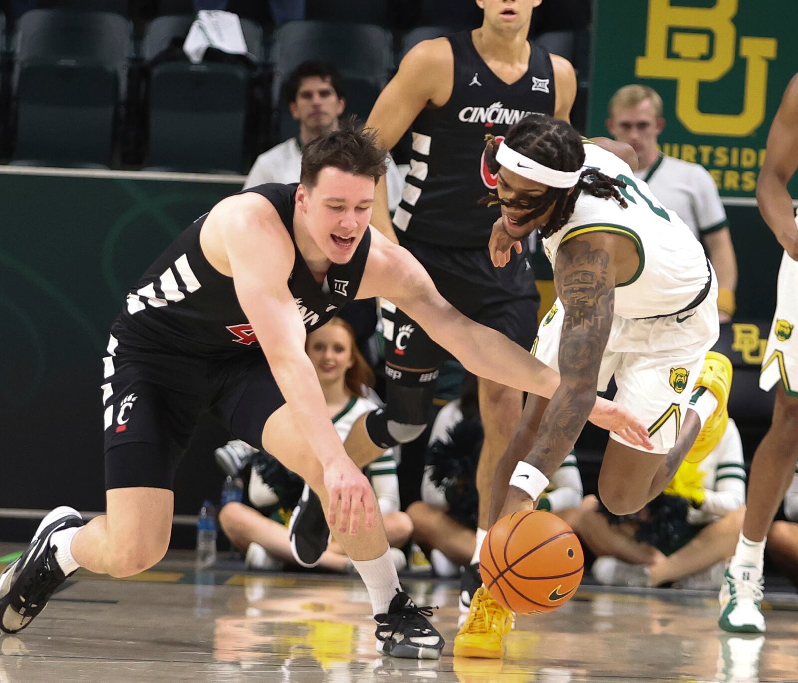 Cincinnati guard Simas Lukosius reaches for a loose ball with Baylor guard Jayden Nunn in the first half of an NCAA college basketball game, Tuesday, Jan. 7, 2025, in Waco, Texas. (Rod Aydelotte/Waco Tribune-Herald via AP)