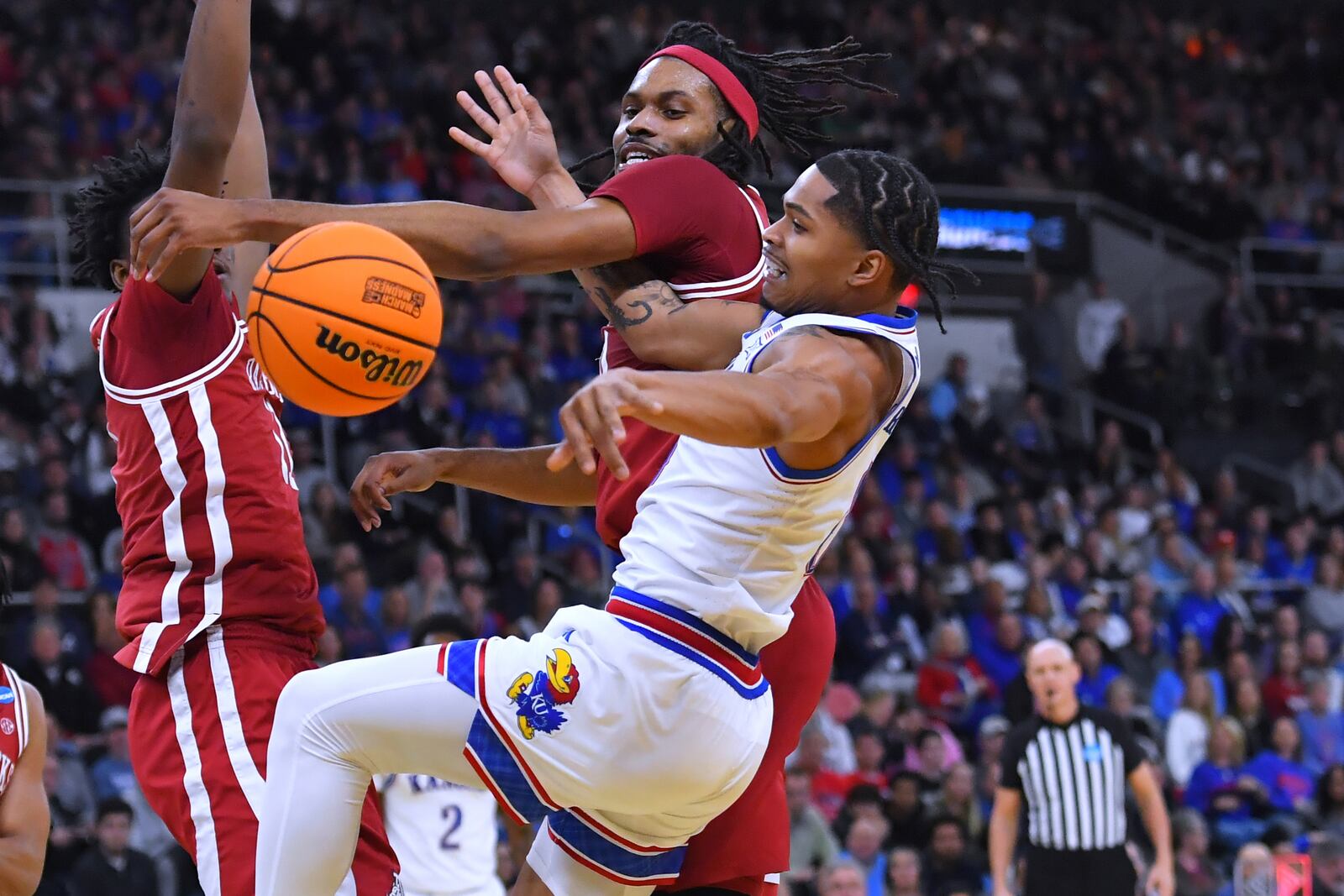 Arkansas forward Jonas Aidoo, rear, battles Kansas guard Zeke Mayo for the ball during the first half in the first round of the NCAA college basketball tournament, Thursday, March 20, 2025, in Providence, R.I. (AP Photo/Steven Senne)