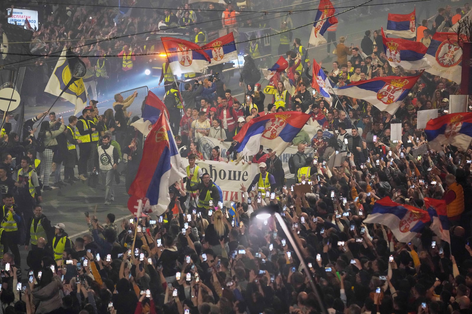 People welcome protesters from provinces who have arrived ahead of a major rally this weekend in downtown Belgrade, Serbia, Friday, March 14, 2025. (AP Photo/Darko Vojinovic)