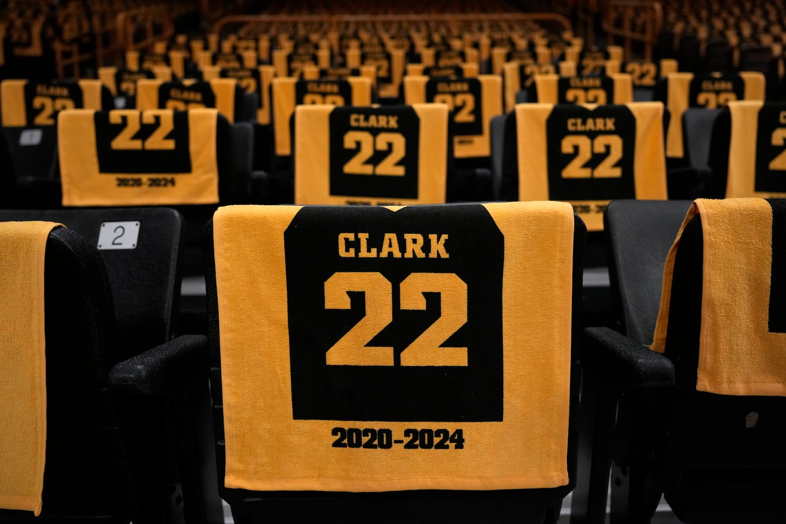 Towels for former Iowa guard and current Indiana Fever WNBA player Caitlin Clark sit in fans' seats before a jersey retirement ceremony following an NCAA college basketball game between Iowa and USC, Sunday, Feb. 2, 2025, in Iowa City, Iowa. (AP Photo/Charlie Neibergall)