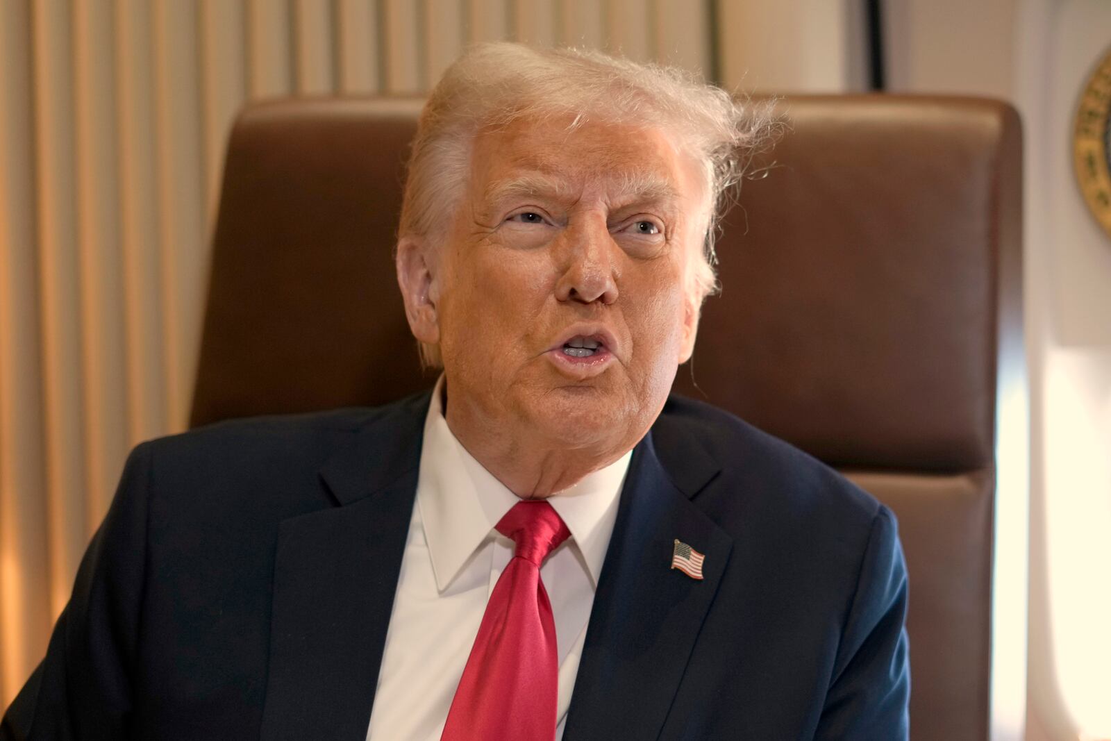 President Donald Trump speaks to reporters aboard Air Force One where he signed a proclamation declaring Feb. 9 Gulf of America Day as he travels from West Palm Beach, Fla. to New Orleans, Sunday, Feb. 9, 2025. (AP Photo/Ben Curtis)