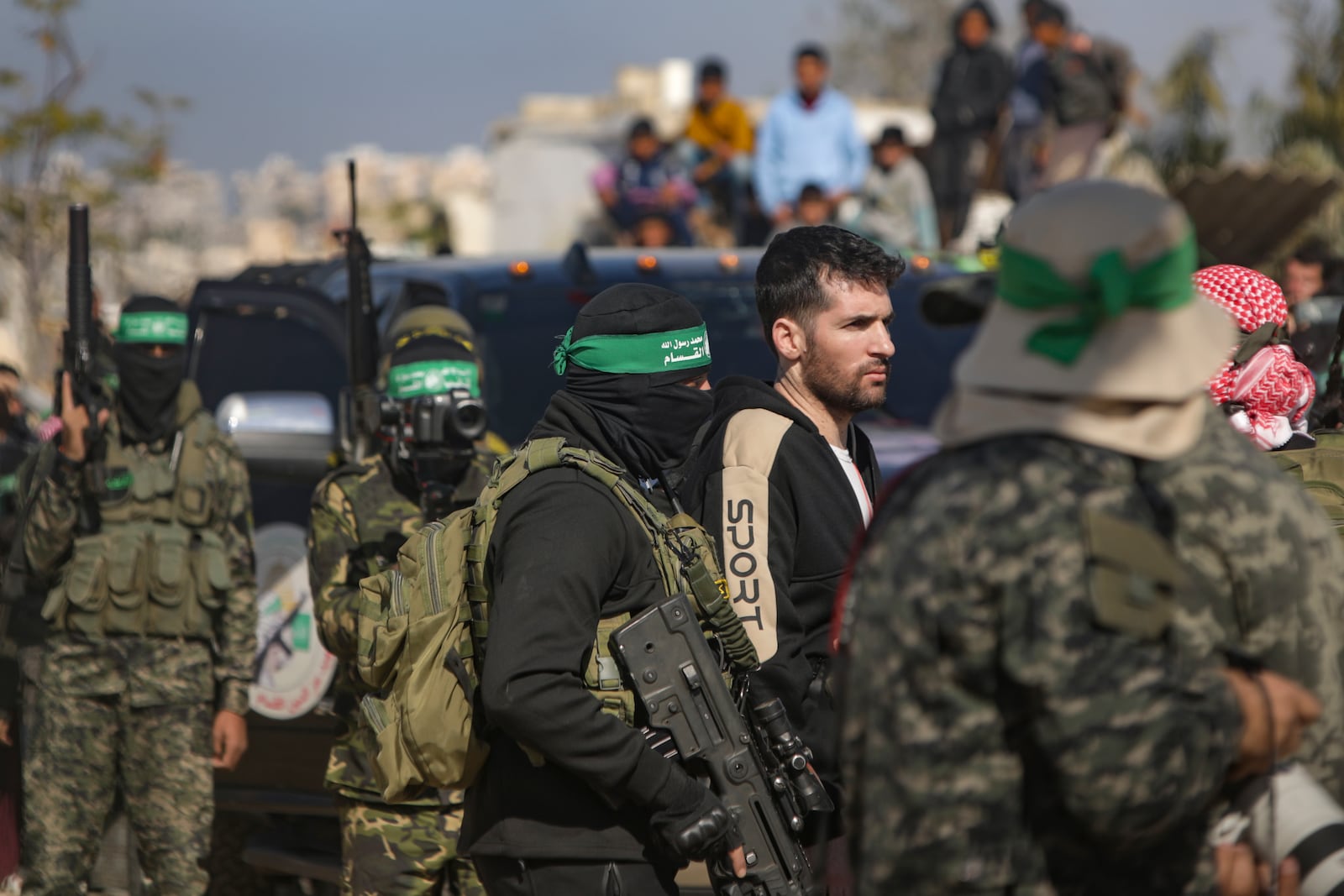 American-Israeli captive Sagui Dekel Chen, 36, is escorted by Hamas fighters as he is handed over to the Red Cross in Khan Younis, Gaza Strip, Saturday, Feb. 15, 2025. (AP Photo/Jehad Alshrafi)