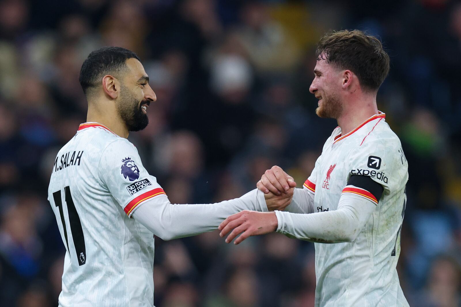 Liverpool's Mohamed Salah, left, celebrates with Liverpool's Alexis Mac Allister after scoring the opening goal during the English Premier League soccer match between Aston Villa and Liverpool at Villa Park in Birmingham, England, Wednesday, Feb. 19, 2025. (AP Photo/Darren Staples)