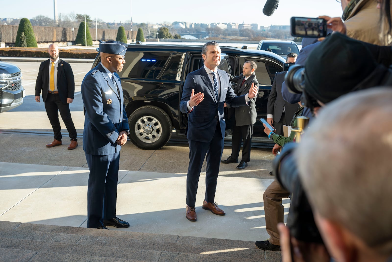 Defense Secretary Pete Hegseth, center right, talks to members of the press after arriving at the Pentagon, Monday, Jan. 27, 2025 in Washington. With Hegseth is Chairman of the Joint Chiefs of Staff Gen. Charles Q. Brown Jr., center left.(AP Photo/Kevin Wolf)