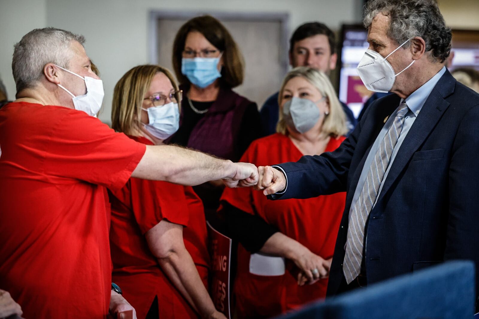 Ohio Sen. Sherrod Brown fist pumps Cincinnati VA nurse, Eric Cromer at a press conference Tuesday April 11, 2023 at Central State West Campus. Senator Brown is co-sponsoring a bill in congress called the nurse staffing standards for hospital patient safety and quality act. JIM NOELKER/STAFF