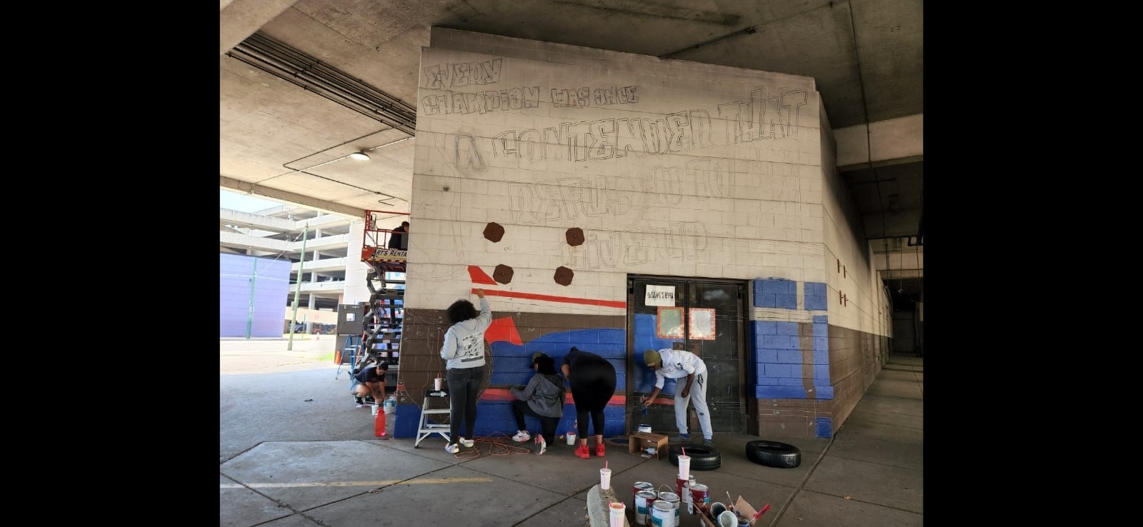 Members of the HAALO juvenile courts program work on mural. CONTRIBUTED