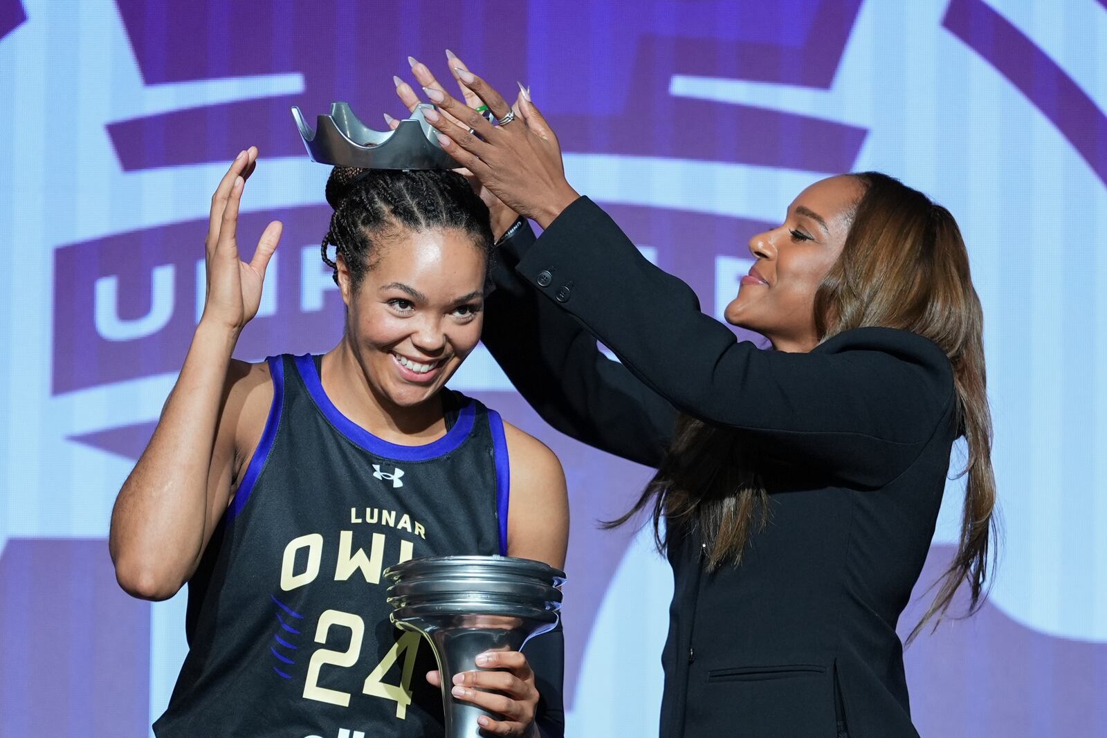 Napheesa Collier, nicknamed "Queen Phee," is presented with a crown as she celebrates after defeating Aaliyah Edwards in the Unrivaled 1-on-1 basketball final, in Friday, Feb. 14, 2025, in Medley, Fla. (AP Photo/Rebecca Blackwell)