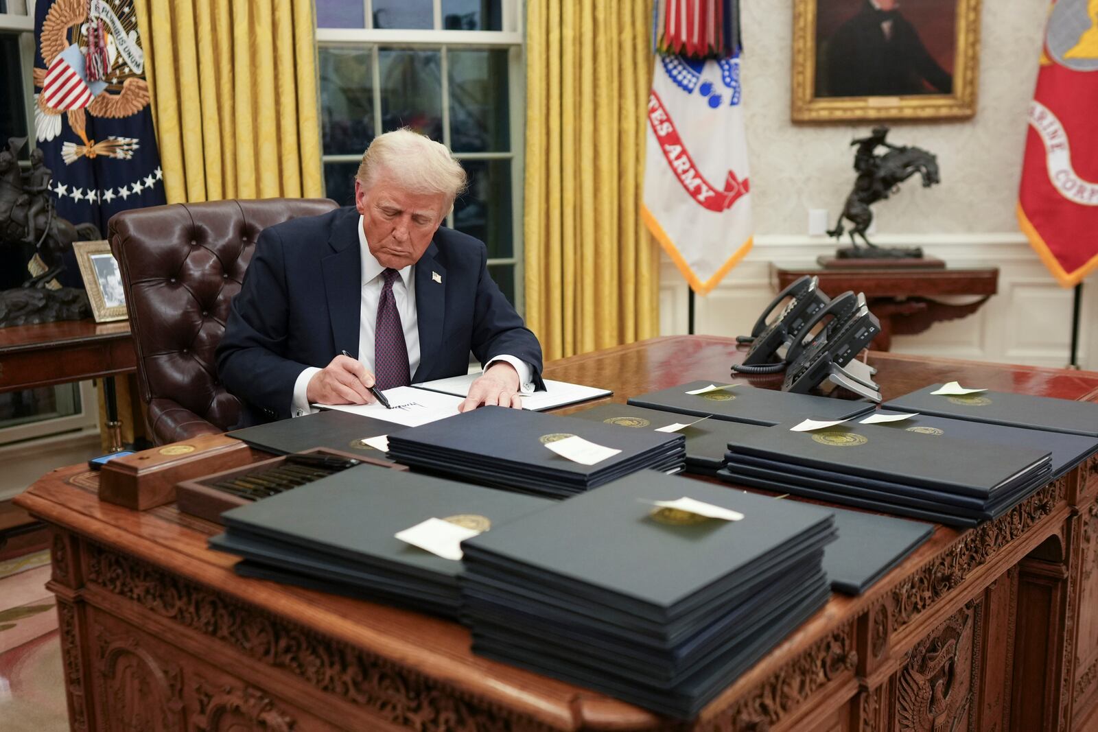 
                        President Donald Trump signs executive orders in the Oval Office of the White House in Washington on Monday, Jan. 20, 2025. Even more than in his first term, Trump has mounted a fundamental challenge to the norms and expectations of what a president can and should do. (Doug Mills/The New York Times)
                      