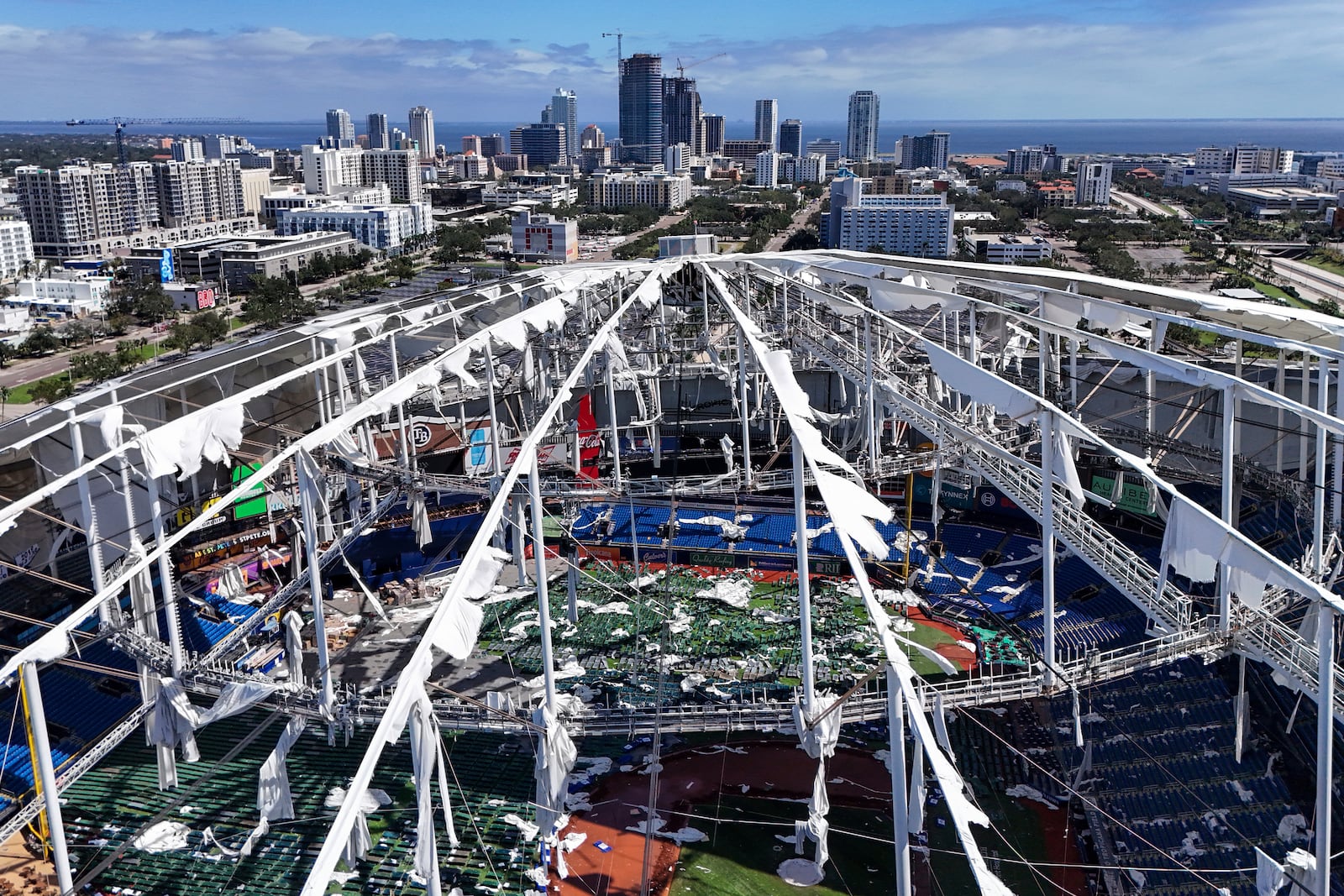 FILE - The roof of the Tropicana Field is damaged the morning after Hurricane Milton hit the region, Oct. 10, 2024, in St. Petersburg, Fla. (AP Photo/Mike Carlson, File)