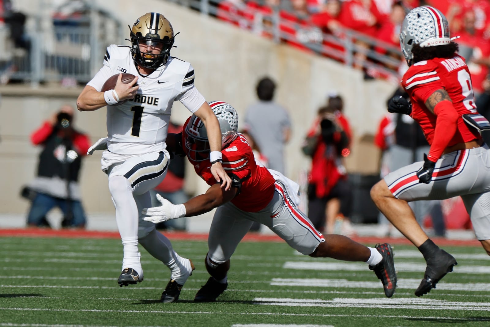 Ohio State defensive back Sonny Styles, right, tries to tackle Purdue quarterback Hudson Card during the first half of an NCAA college football game Saturday, Nov. 9, 2024, in Columbus, Ohio. (AP Photo/Jay LaPrete)