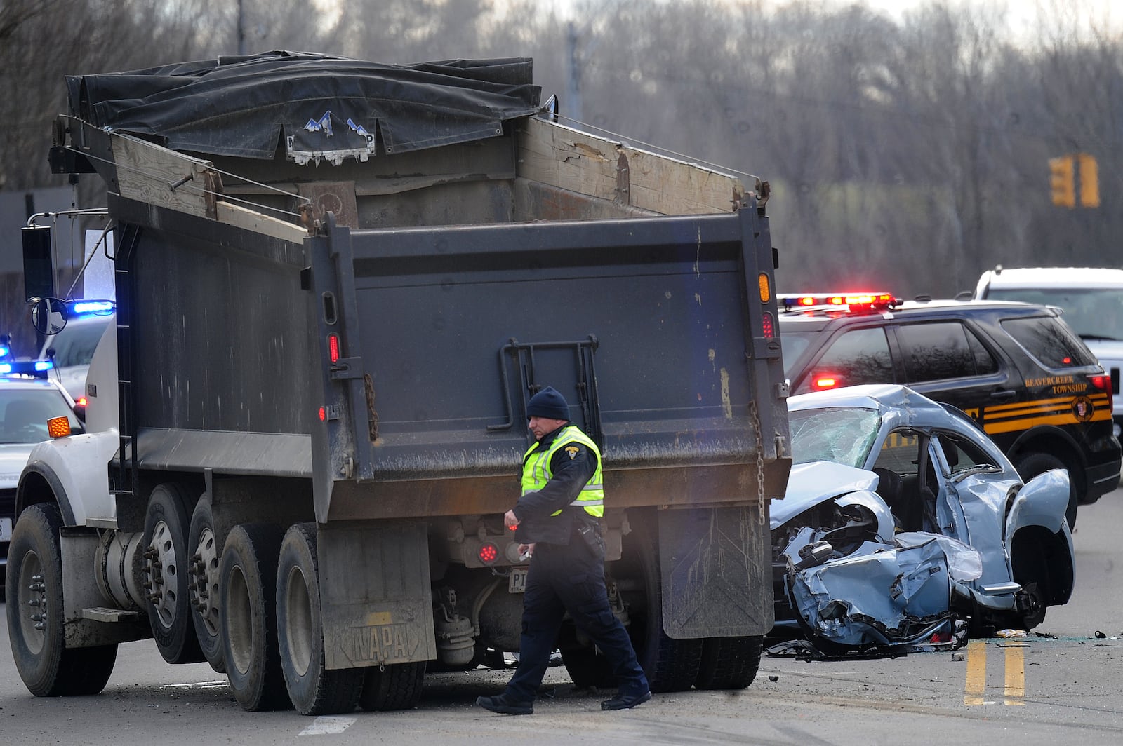 A teen girl was killed and two more teens were injured in a crash involving a car and dump truck at the intersection of Treibein and Dayton-Xenia roads in Beavercreek Twp. MARSHALL GORBY / STAFF