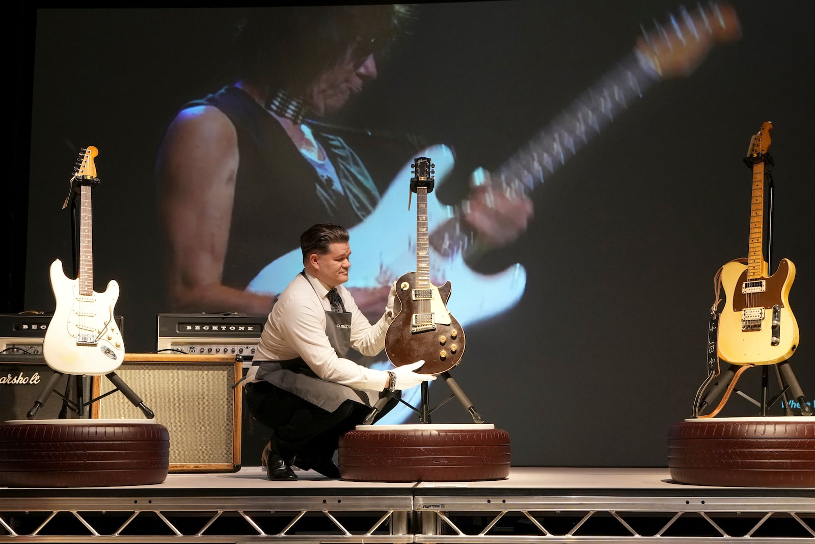 An art handler displays a Gibson, Kalamazoo, Michigan, circa 1959 and later A Solid-Body Electric Guitar, Les Paul, known as "The Yardburst," at the Jeff Beck The Guitar Collection in London, Tuesday, Jan. 14, 2025, ahead of the pre-sale exhibition at Christies auction rooms in London. (AP Photo/Kirsty Wigglesworth)