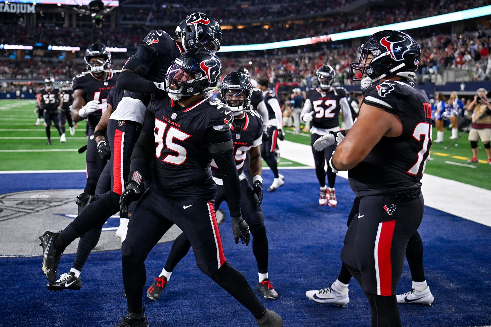 Houston Texans defensive end Derek Barnett (95) celebrates with teammates after scoring on a fumble recovery during the second half of an NFL football game against the Dallas Cowboys, Monday, Nov. 18, 2024, in Arlington, Texas. (AP Photo/Jerome Miron)