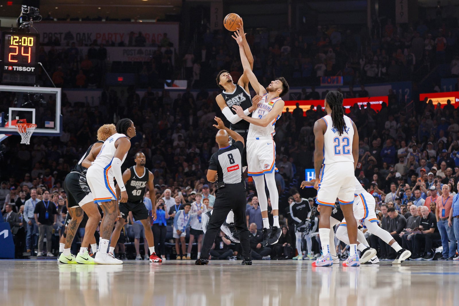 San Antonio Spurs center Victor Wembanyama, center left, and Oklahoma City Thunder forward Chet Holmgren, center right, jump for the opening tip-off to start the first half of an NBA basketball game, Wednesday, Oct. 30, 2024, in Oklahoma City. (AP Photo/Nate Billings)