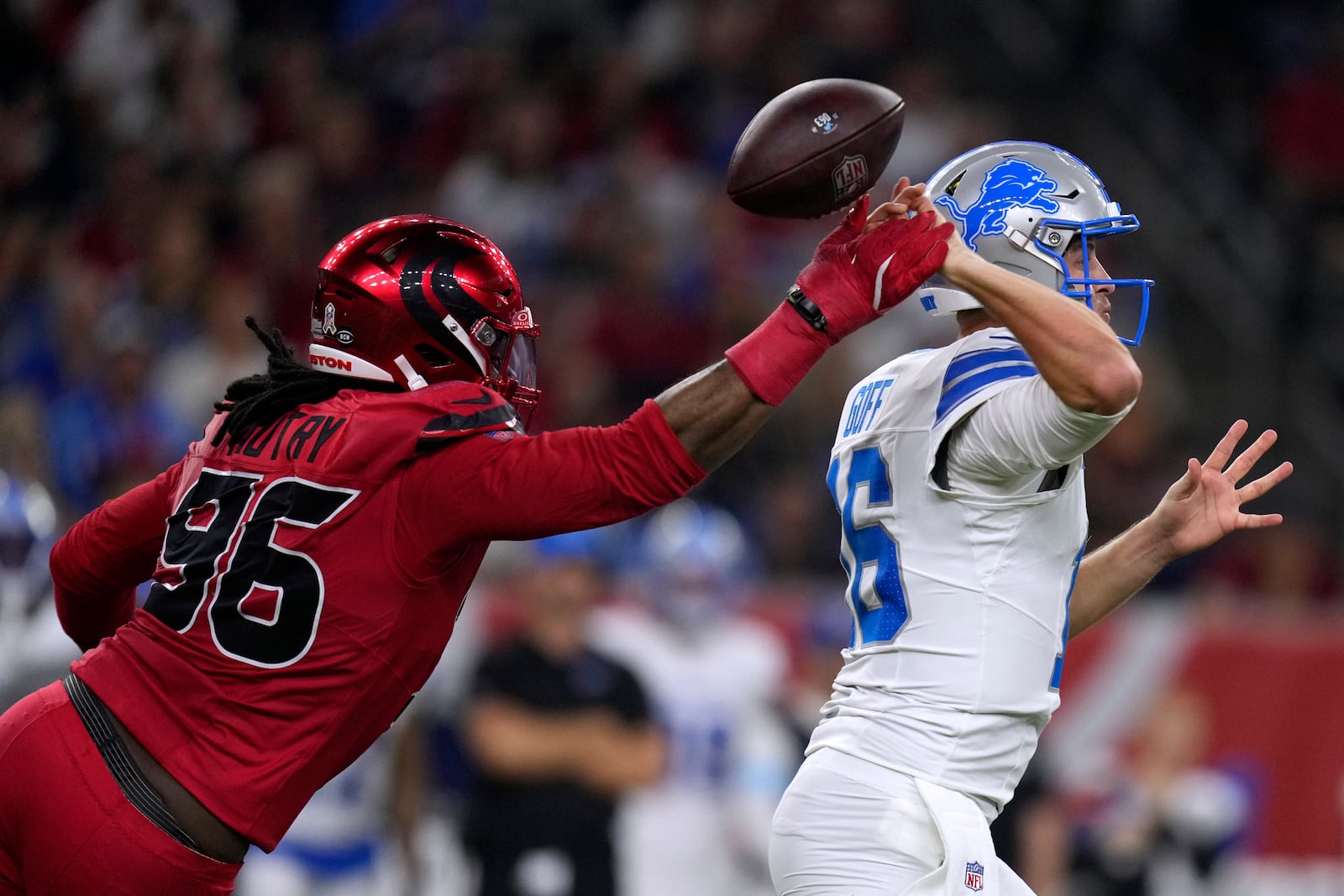 Houston Texans defensive end Denico Autry (96) hits Detroit Lions quarterback Jared Goff (16) as he throws a pass during the first half of an NFL football game, Sunday, Nov. 10, 2024, in Houston. (AP Photo/Eric Christian Smith)