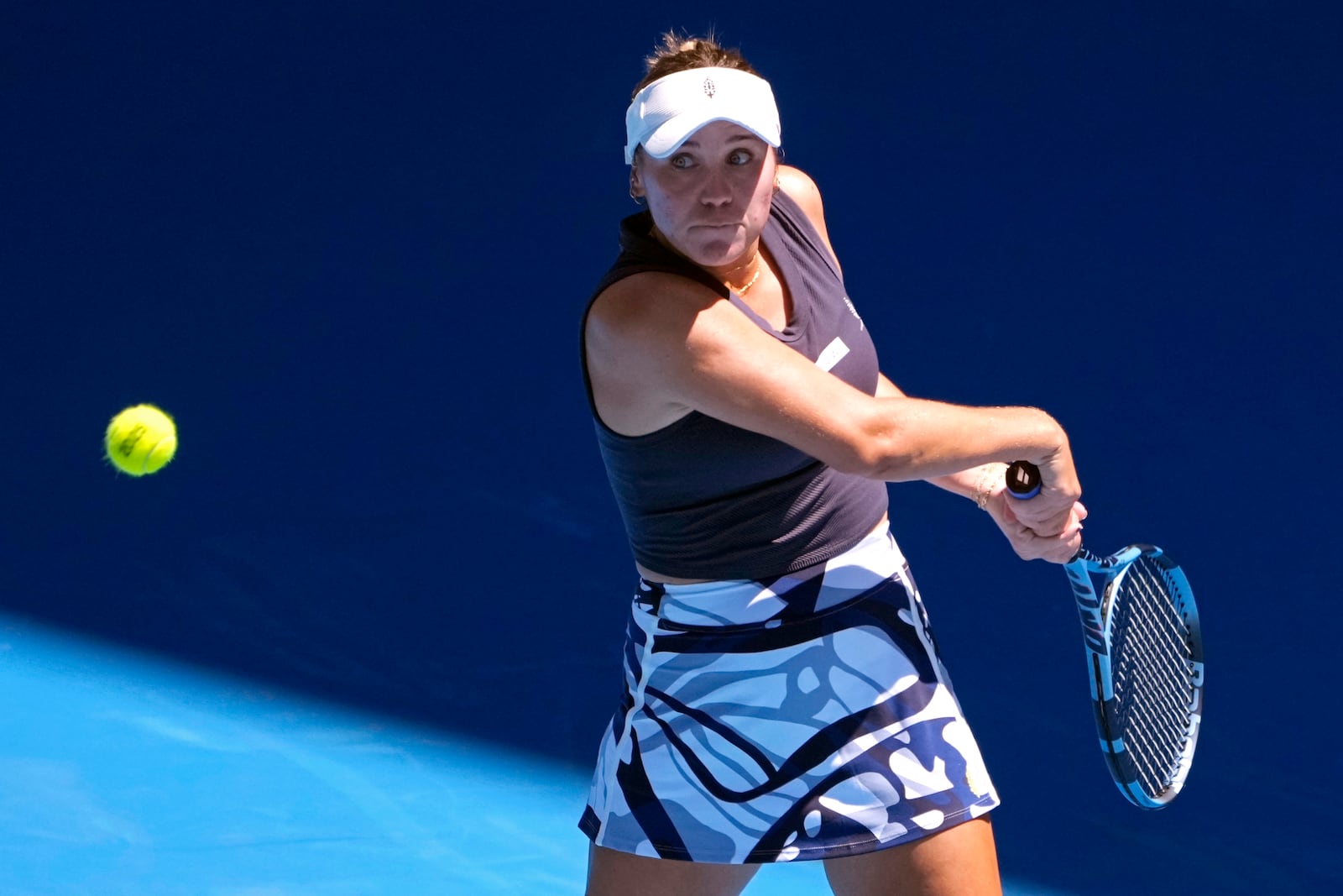 Sofia Kenin of the U.S. plays a backhand return to Coco Gauff of the U.S. during their first round match at the Australian Open tennis championship in Melbourne, Australia, Monday, Jan. 13, 2025. (AP Photo/Asanka Brendon Ratnayake)