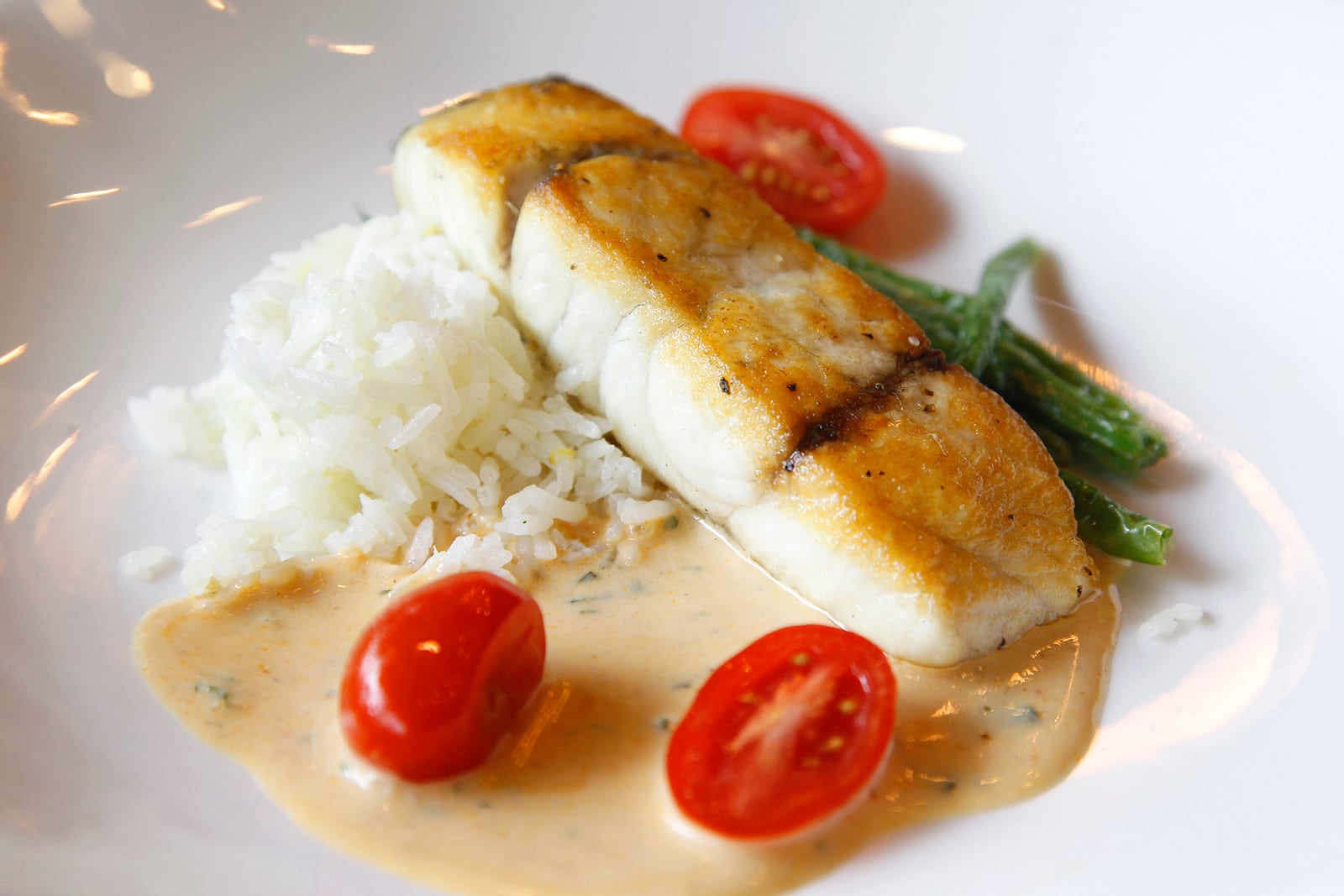 Cooperâs Hawk Winery & Restaurant, located in the Cornerstone of Centerville, opens Monday, Aug. 26.  Pan-roasted barramundi with blistered green beans, grape tomatoes, ginger rice and Thai lemongrass sauce is one of the entrees on the menu. LISA POWELL / STAFF