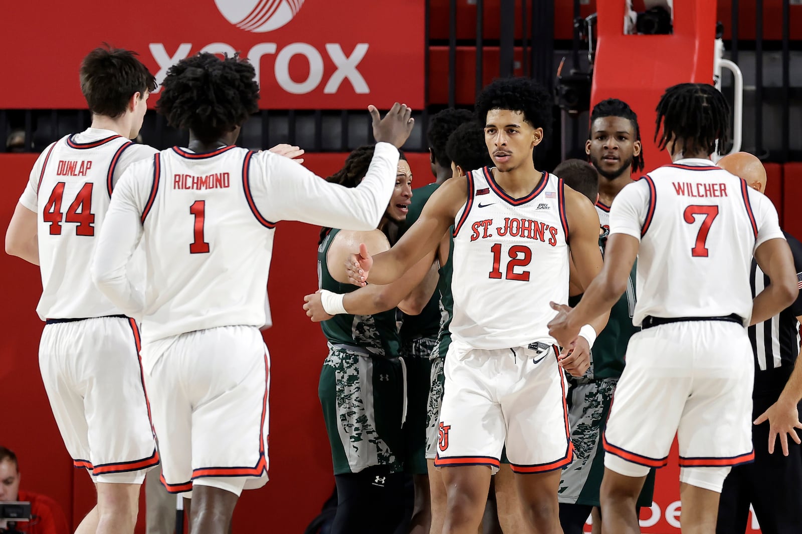 St. John's guard RJ Luis Jr. (12) reacts with teammates during the first half of an NCAA college basketball game against Wagner Wednesday, Nov. 13, 2024, in New York. (AP Photo/Adam Hunger)