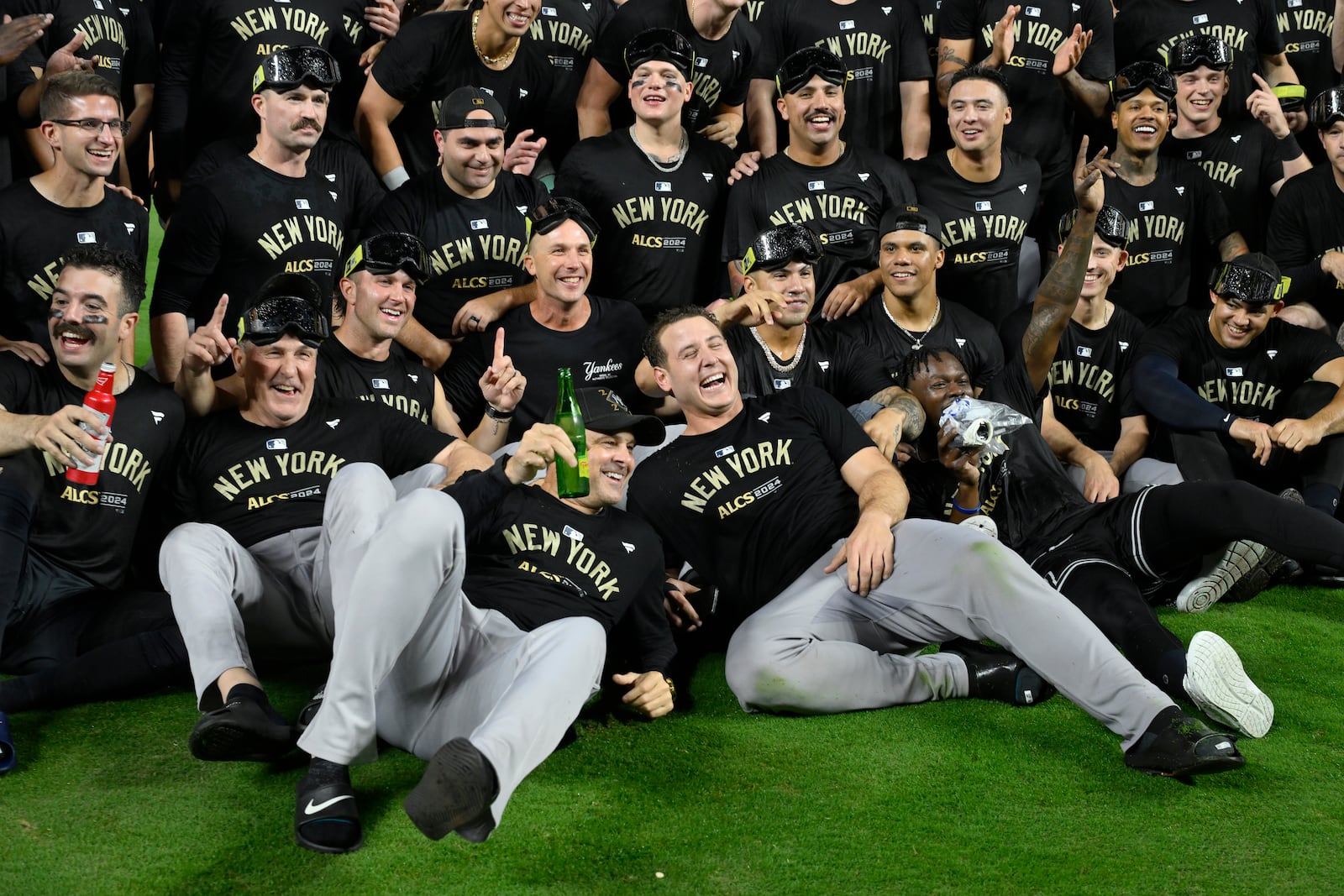 Members of the New York Yankees celebrate following a 3-1 victory over the Kansas City Royals in Game 4 of an American League Division baseball playoff series Thursday, Oct. 10, 2024, in Kansas City, Mo. (AP Photo/Reed Hoffmann)