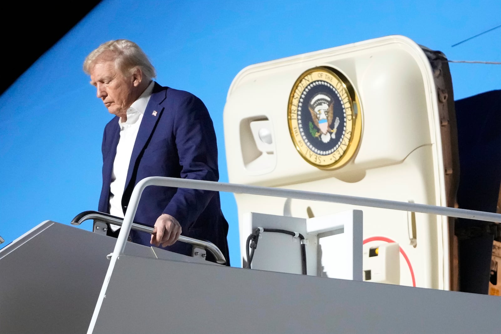 President Donald Trump arrives on Air Force One at Harry Reid International Airport in Las Vegas, Friday, Jan. 24, 2025. (AP Photo/Mark Schiefelbein)