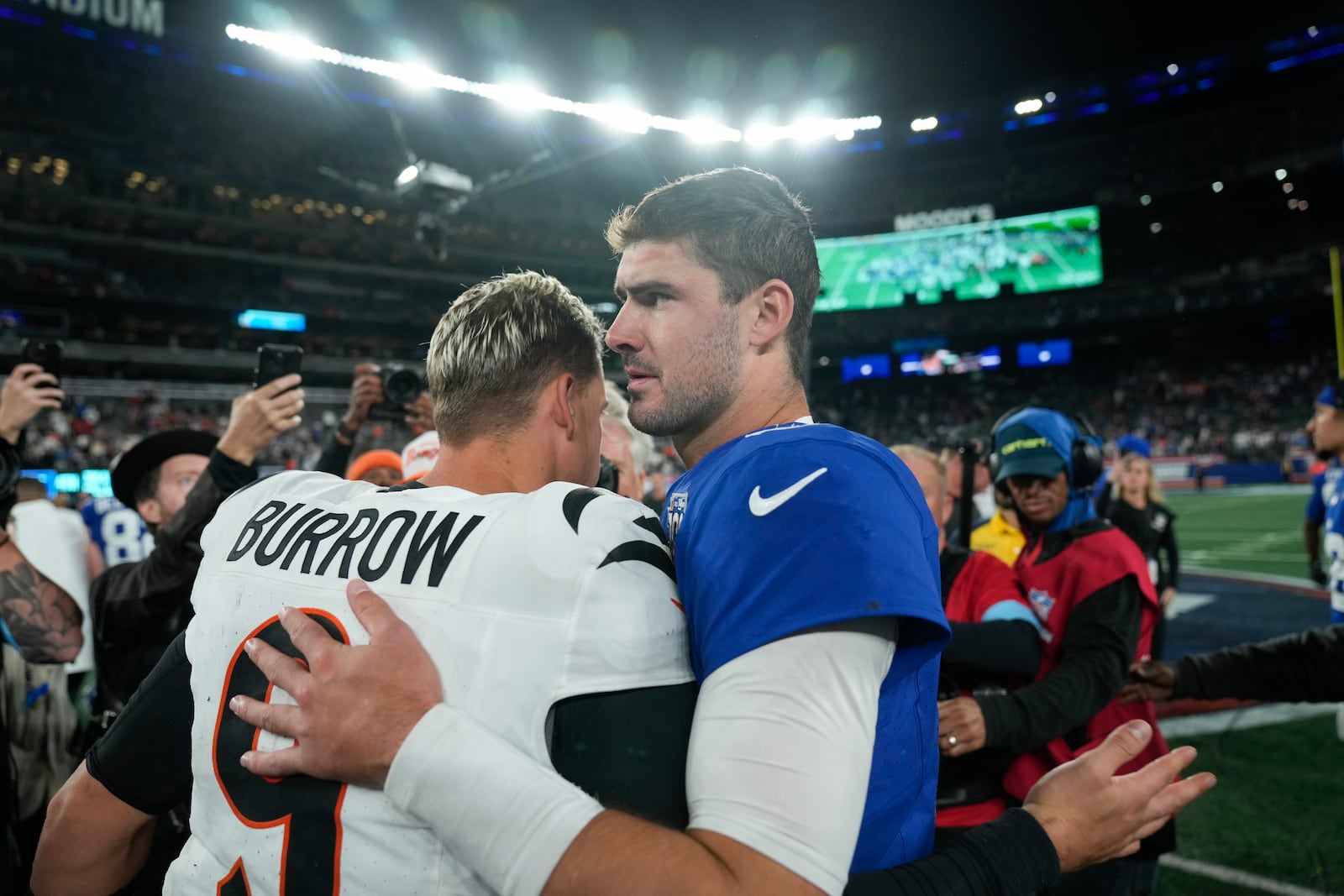 Cincinnati Bengals quarterback Joe Burrow (9) and New York Giants quarterback Daniel Jones, right, greet each other on the field after an NFL football game, Sunday, Oct. 13, 2024, in East Rutherford, N.J. The Bengals won 17-7. (AP Photo/Seth Wenig)