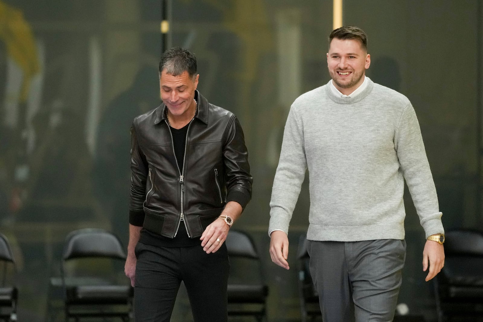 Los Angeles Lakers' Luka Doncic, right, walks to the podium with general manger Rob Pelinka during an introductory NBA basketball press conference Tuesday, Feb. 4, 2025, in El Segundo, Calif. (AP Photo/Jae C. Hong)