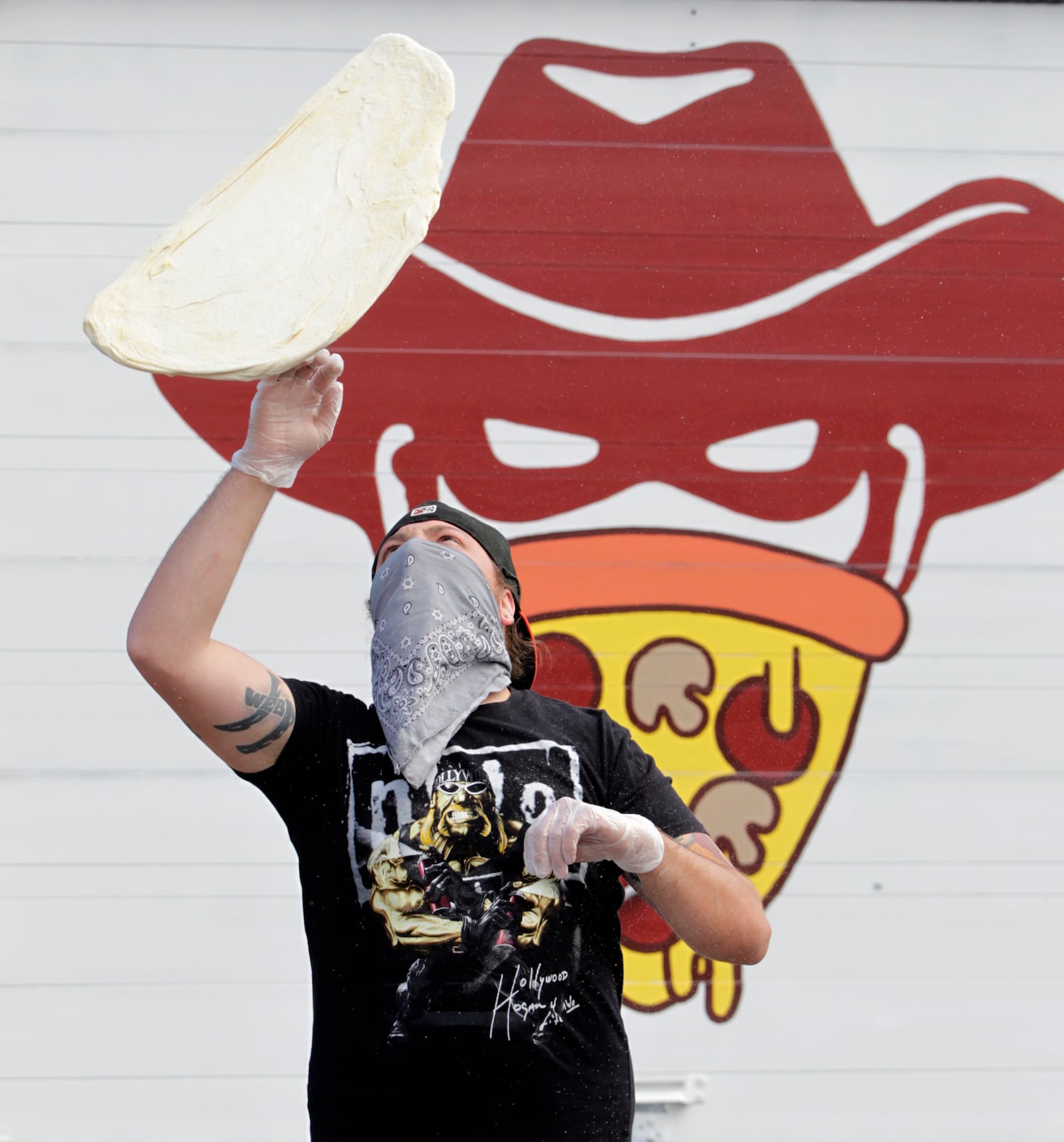 James Burton is one of the owners of The Pizza Bandit, a New York style pizza truck that can be found at the Yellow Cab Tavern in Dayton.  LISA POWELL / STAFF