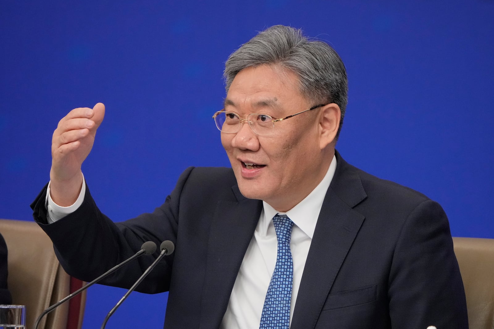 Wang Wentao, Commerce Minister speaks during a press conference on the sideline of the National People's Congress in Beijing, China, Thursday, March 6, 2025. (AP Photo/Vincent Thian)