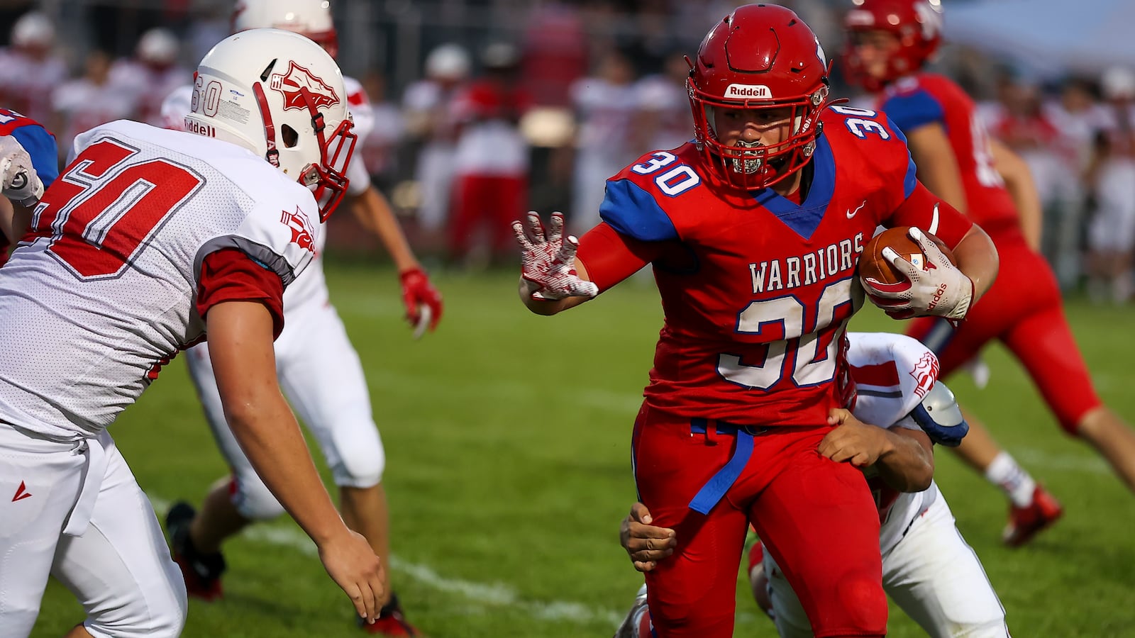 Northwestern High School senior Kolten Berner motions to stiff arm Stebbins freshman Landon Wickman during their game on Thursday, Aug. 19 at Taylor Field in Springfield. The Indians won 55-14. CONTRIBUTED PHOTO BY MICHAEL COOPER